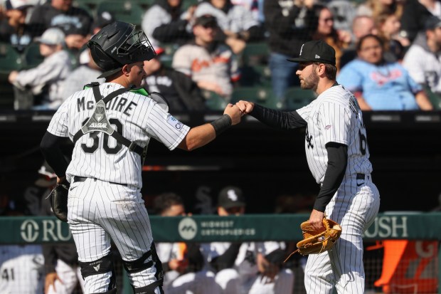 White Sox pitcher Tyler Schweitzer, right, gets a fist bump from catcher Reese McGuire after working the eighth inning against the Orioles at Rate Field on April 8, 2026, in Chicago. It was Schweitzer's major-league debut. (John J. Kim/Chicago Tribune)