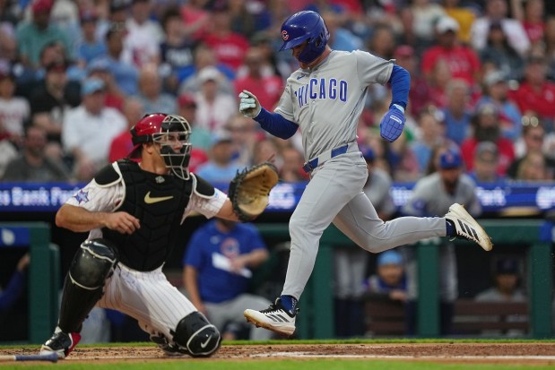 Cubs right fielder Matt Shaw scores past Phillies catcher J.T. Realmuto during the third inning Wednesday, April 15, 2026, in Philadelphia. (Matt Rourke/AP)