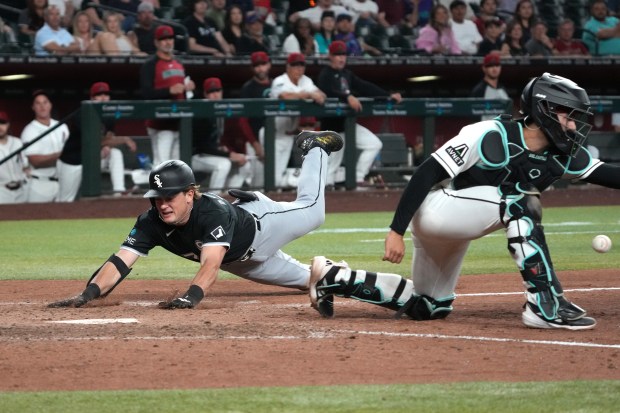 White Sox left fielder Sam Antonacci slides home safely behind Diamondbacks catcher Adrian Del Castillo for an inside-the-park home run in the ninth inning Tuesday, April 21, 2026, in Phoenix. (Rick Scuteri/AP)