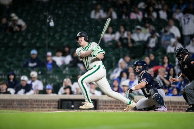 Oak Lawn's Aidan Schopper (19) looks up after connecting on a pitch against Reavis during nonconference game at Wrigley Field in Chicago on Sunday, April 12, 2026. (Vincent D. Johnson / for the Daily Southtown)
