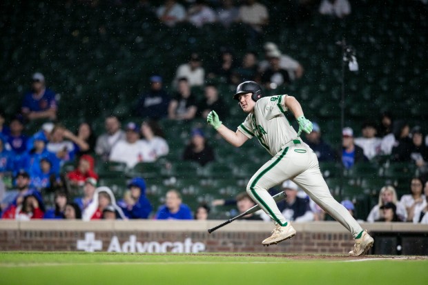 Oak Lawn's Aidan Schopper (19) connects for a triple against Reavis during nonconference game at Wrigley Field in Chicago on Sunday, April 12, 2026. (Vincent D. Johnson / for the Daily Southtown)