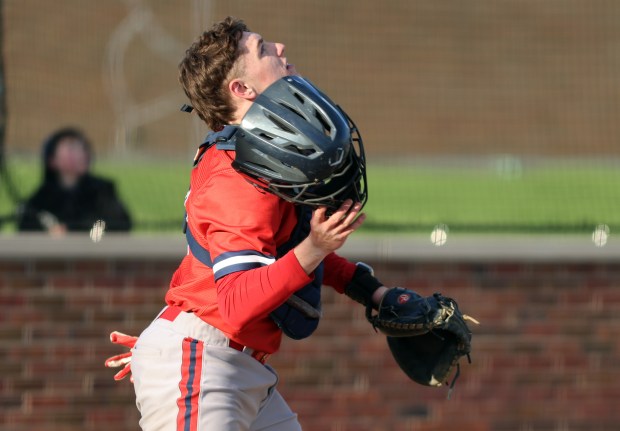 St. Rita's catcher Colin Quinn (27) keeps an eye on a popup during the game against Oak Forest in Chicago on Monday, April 6, 2026 (James C. Svehla / for Daily Southtown)