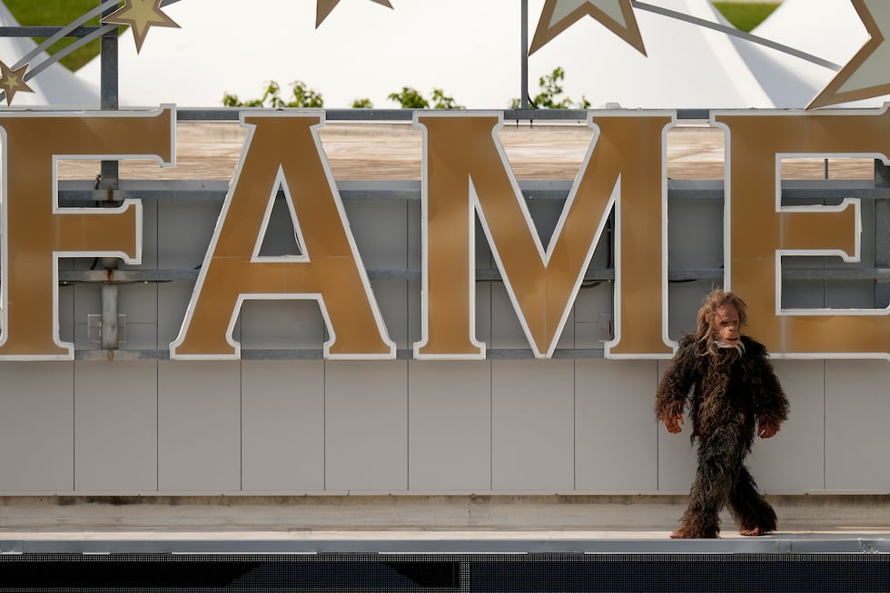 A person dressed as a Sasquatch walks on the roof of the Kansas City Royals Hall of Fame after...
