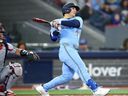 Daulton Varsho, of the Toronto Blue Jays, hits a two-run homer in the first inning of a game against the Minnesota Twins at Rogers Centre in Toronto on April 11, 2026.