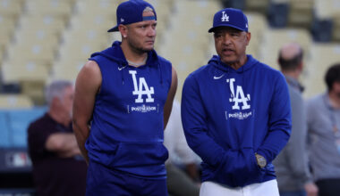Oct 12, 2024; Los Angeles, CA, USA; Los Angeles Dodgers manager Dave Roberts (right) speaks to shortstop Miguel Rojas (left) during the NLCS workouts at Dodgers Stadium. Mandatory Credit: Kiyoshi Mio-Imagn Images