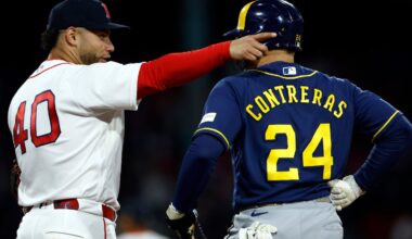 Willson Contreras (lefts) talks to his brother, Brewers catcher William Contreras, during the third inning Monday at Fenway Park as the Red Sox tried to get themselves pointed in the right direction.
