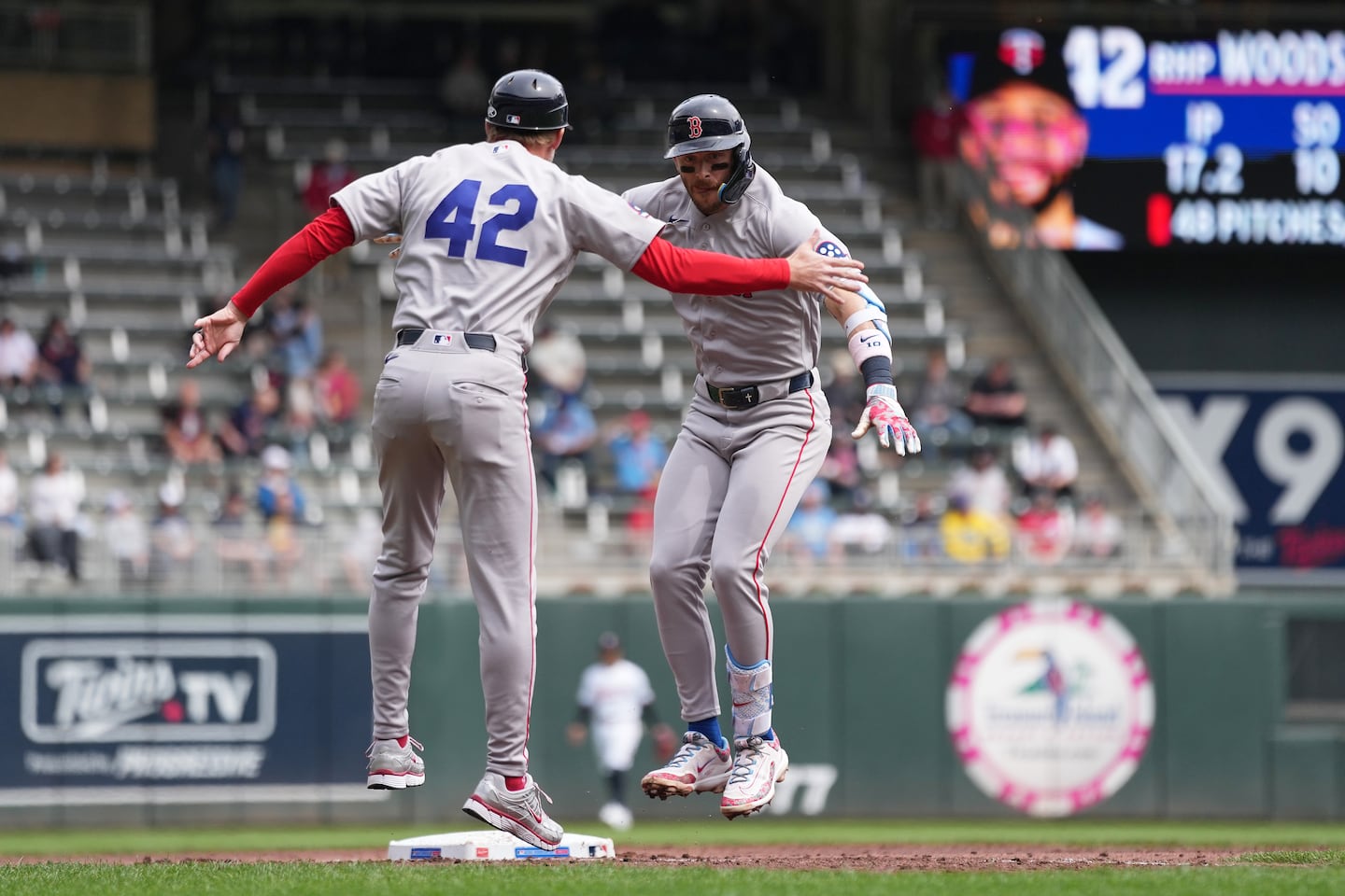 With everyone wearing No. 42 on Jackie Robinson Day, Trevor Story (right) celebrated with third base coach Kyle Hudson after hitting a three-run home run in the third inning.