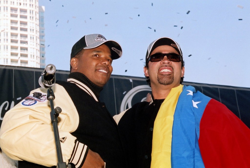 Then Chicago White Sox General Manager and Executive Vice-President Kenny Williams and manager Ozzie Guillén, who is draped in the flag of Venezuela, celebrate during the team's 2005 World Series victory parade in Chicago. 