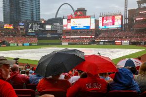 ST. LOUIS, MO - JULY 27: Fans wait in the rain as the start of a baseball game between the Washington Nationals and the St. Louis Cardinals at Busch Stadium on July 27, 2024 in St. Louis, Missouri has been delayed. (Photo by Scott Kane/Getty Images)