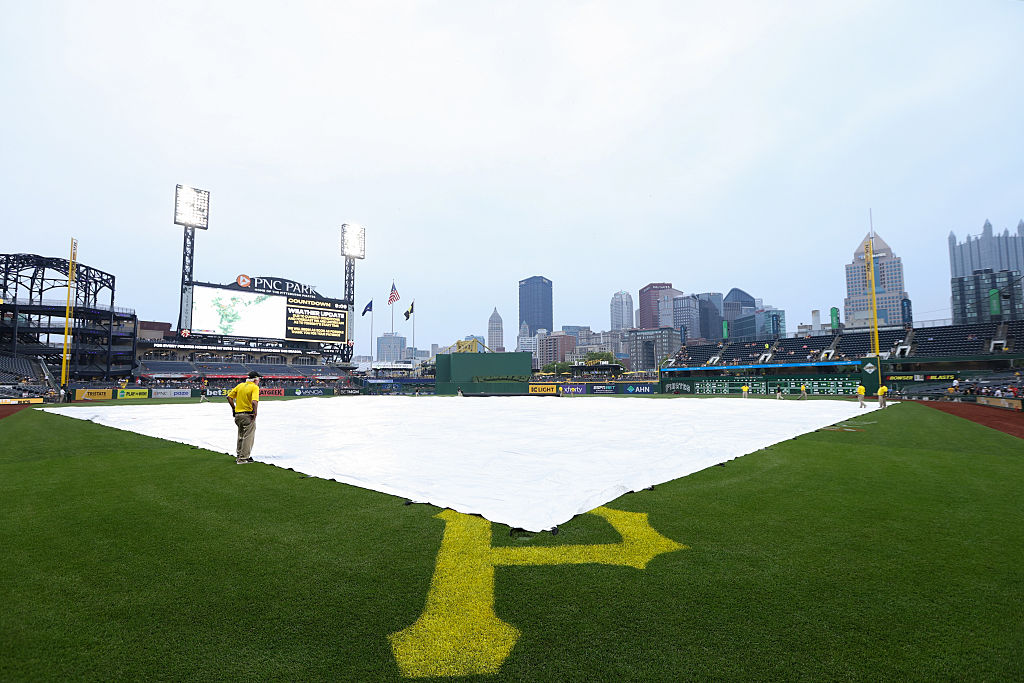 PITTSBURGH, PA - JUNE 05: Members of the grounds crew cover the field for a rain delay prior to the game between the Houston Astros and the Pittsburgh Pirates at PNC Park on Thursday, June 5, 2025 in Pittsburgh, Pennsylvania. (Photo by Rayni Shiring/MLB Photos via Getty Images)