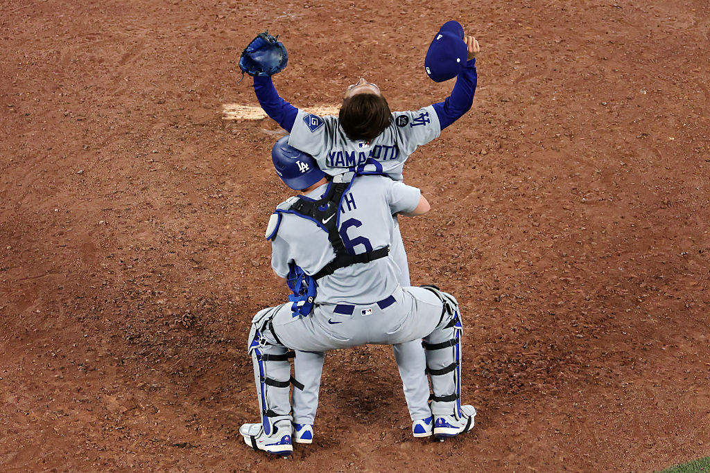 TORONTO, ONTARIO - NOVEMBER 02: (L-R) Yoshinobu Yamamoto #18 and Will Smith #16 of the Los Angeles Dodgers celebrate after defeating the Toronto Blue Jays 5-4 in game seven of the 2025 World Series at Rogers Center on November 02, 2025 in Toronto, Ontario. (Photo by Patrick Smith/Getty Images)