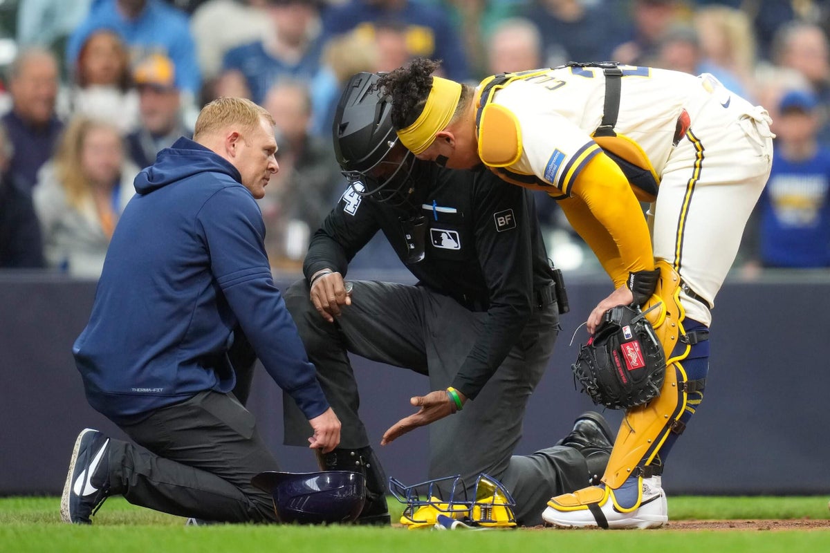 Umpire CB Bucknor leaves game after taking a foul ball off his facemask