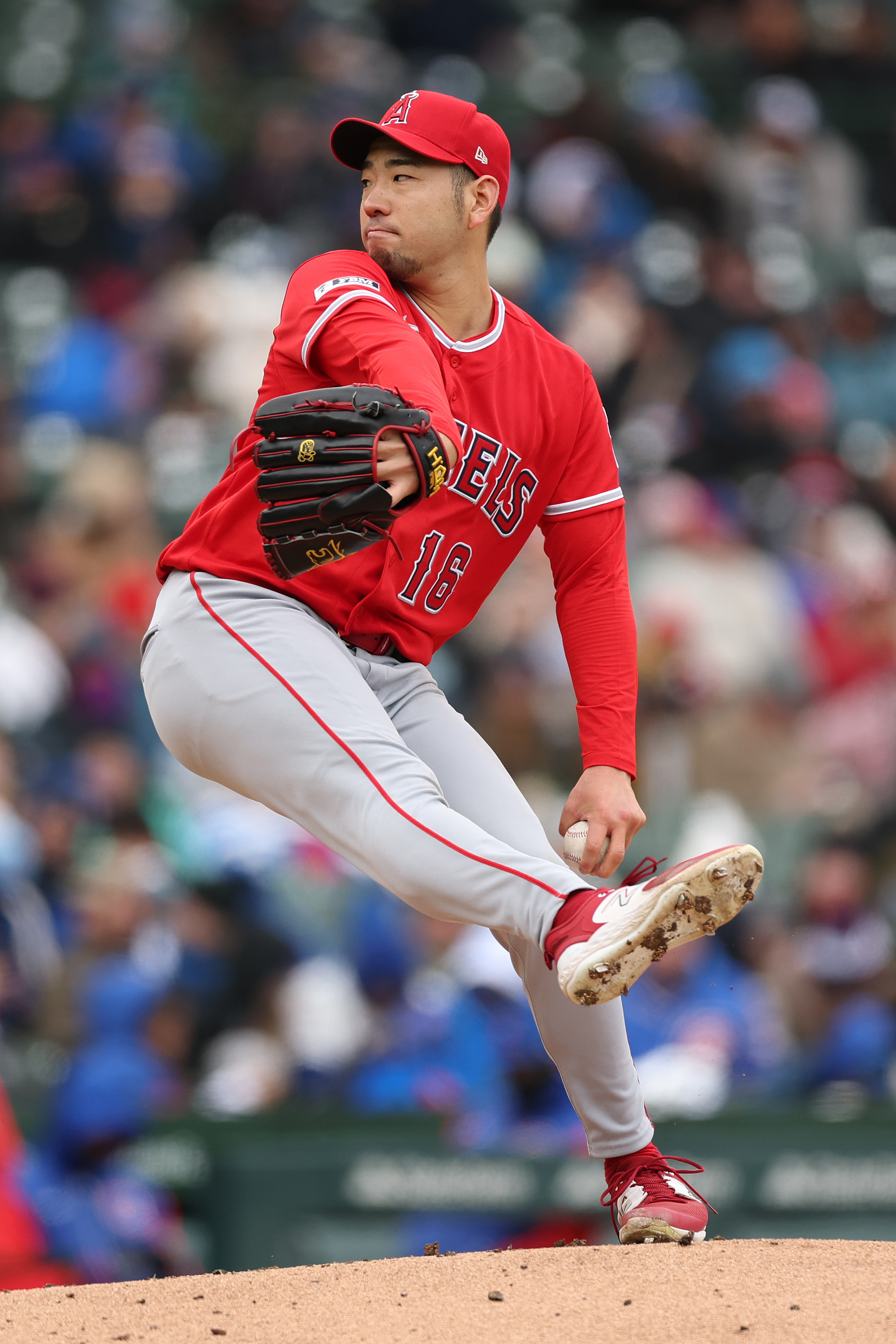 Angels starting pitcher Yusei Kikuchi throws to the plate during...