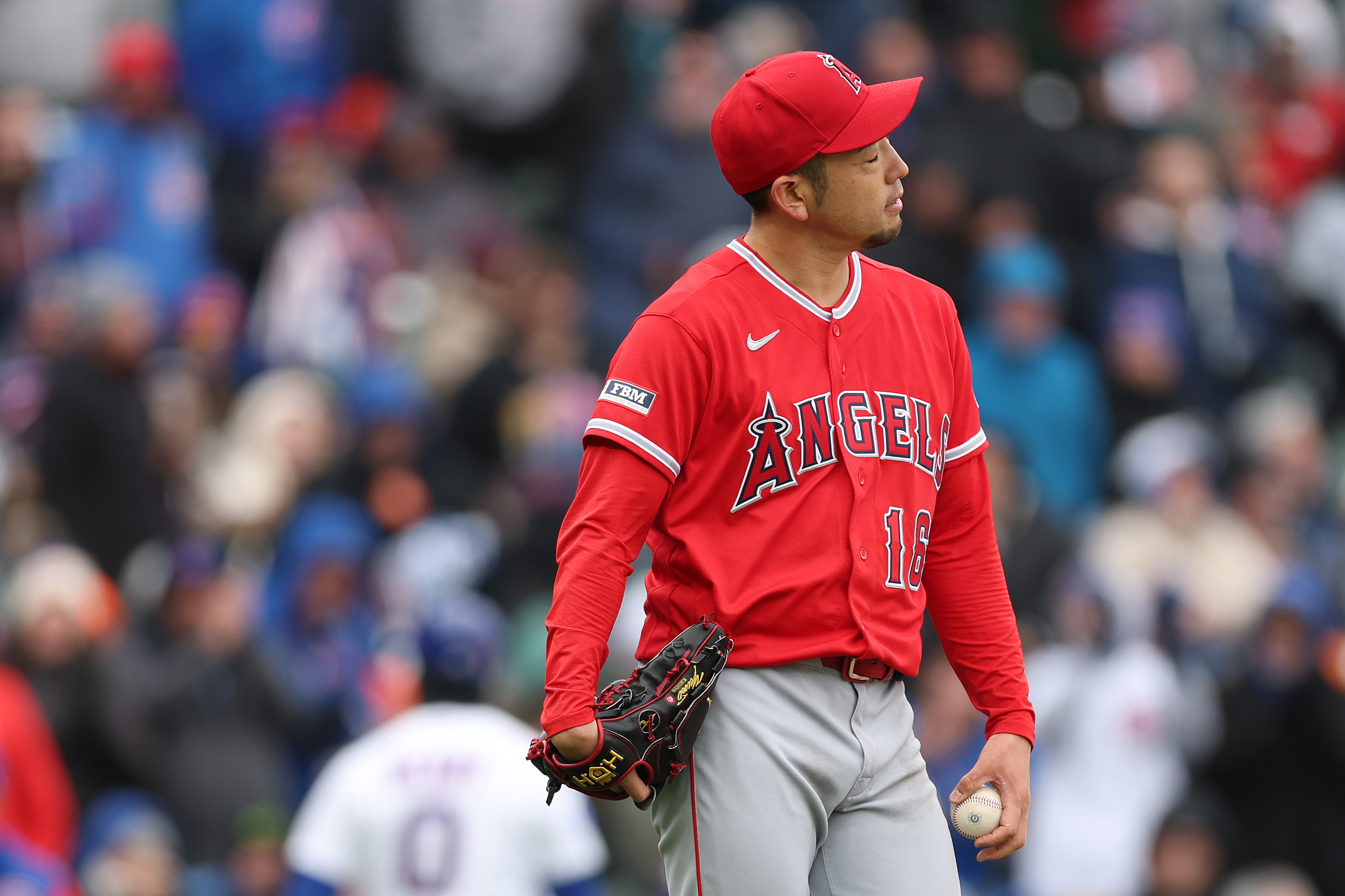 Angels starting pitcher Yusei Kikuchi reacts during the third inning...