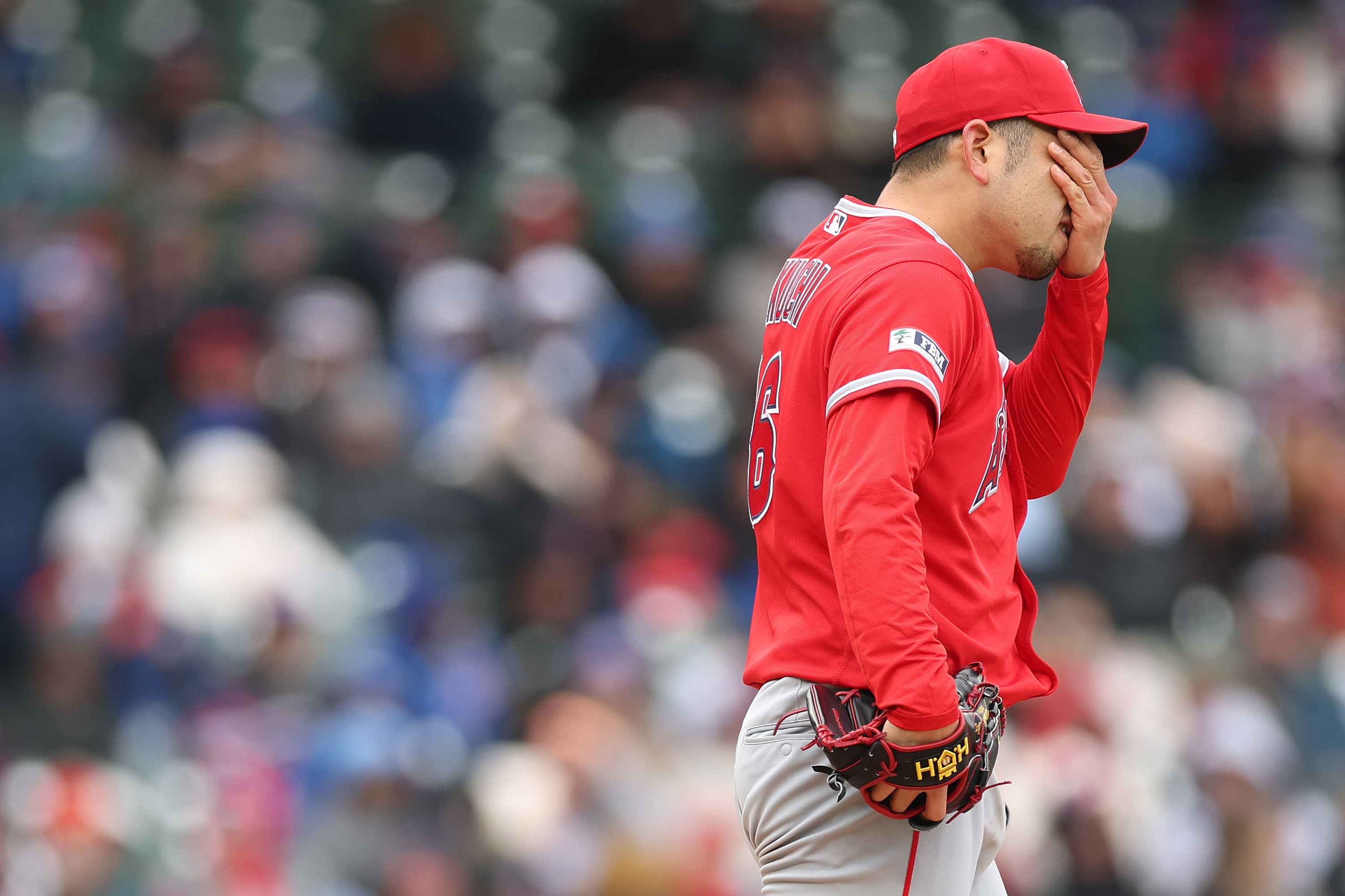Angels starting pitcher Yusei Kikuchi reacts during the third inning...