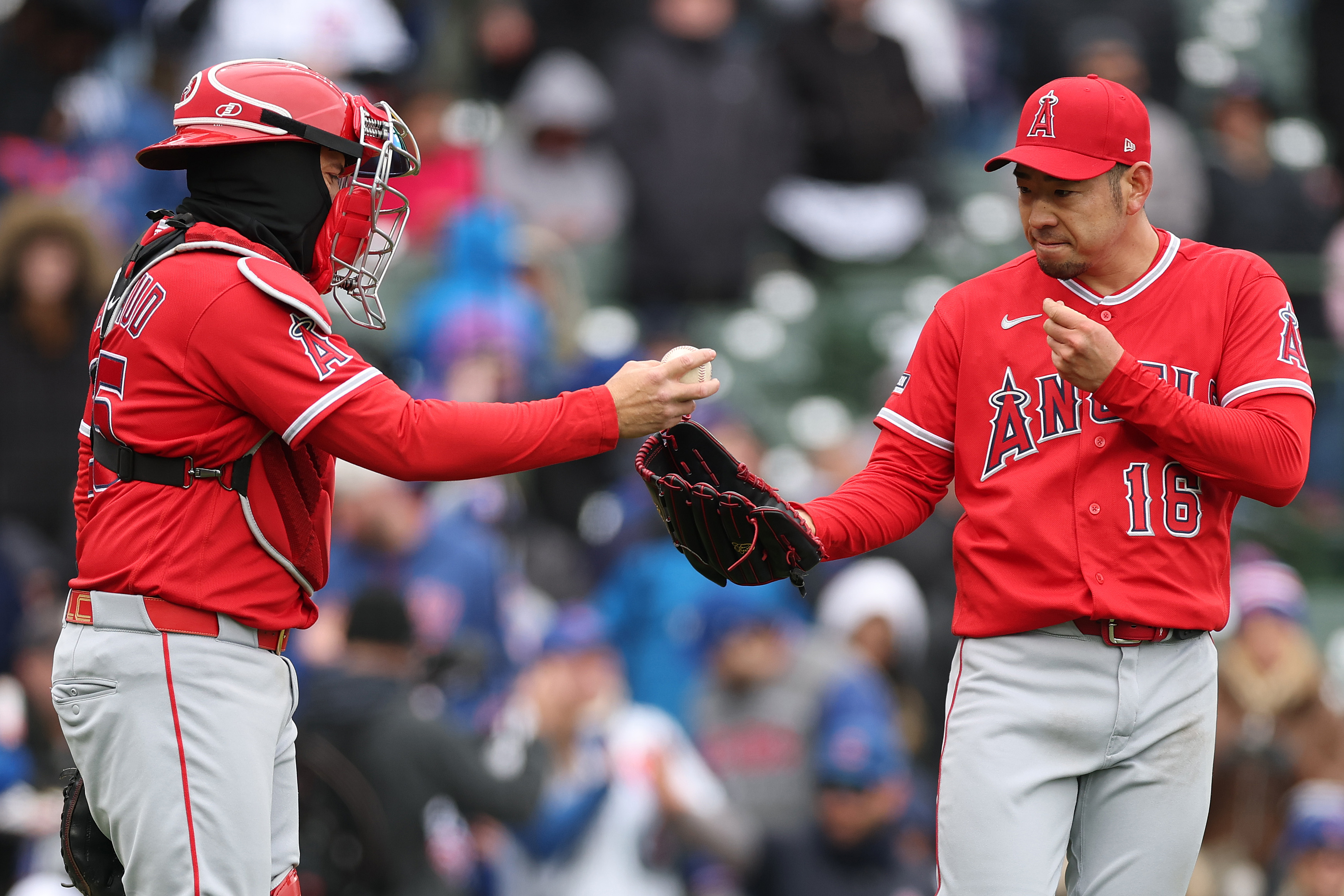 Angels starting pitcher Yusei Kikuchi, right, talks with catcher Travis...