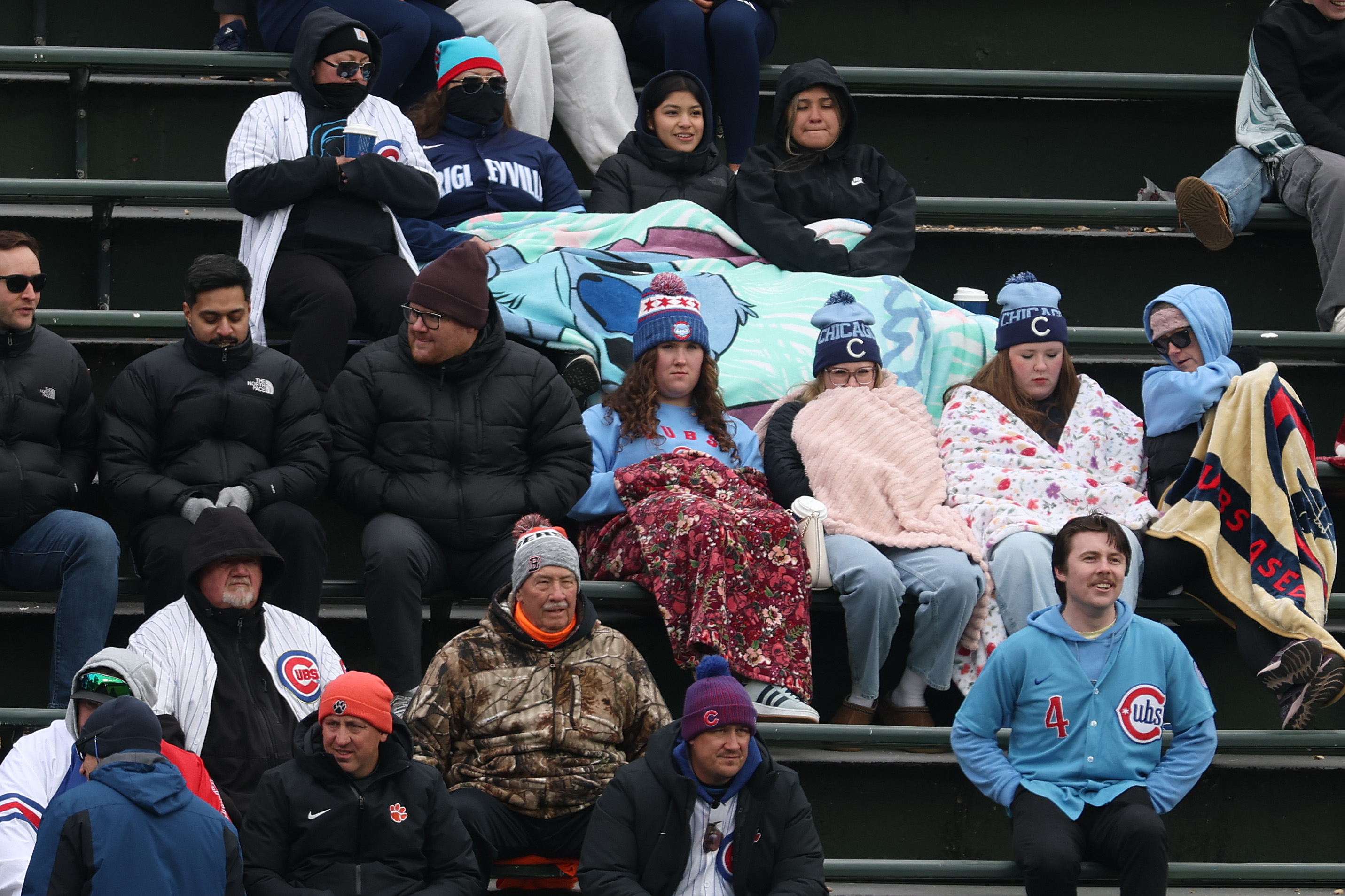Chicago Cubs fans use blankets to try and stay warm...