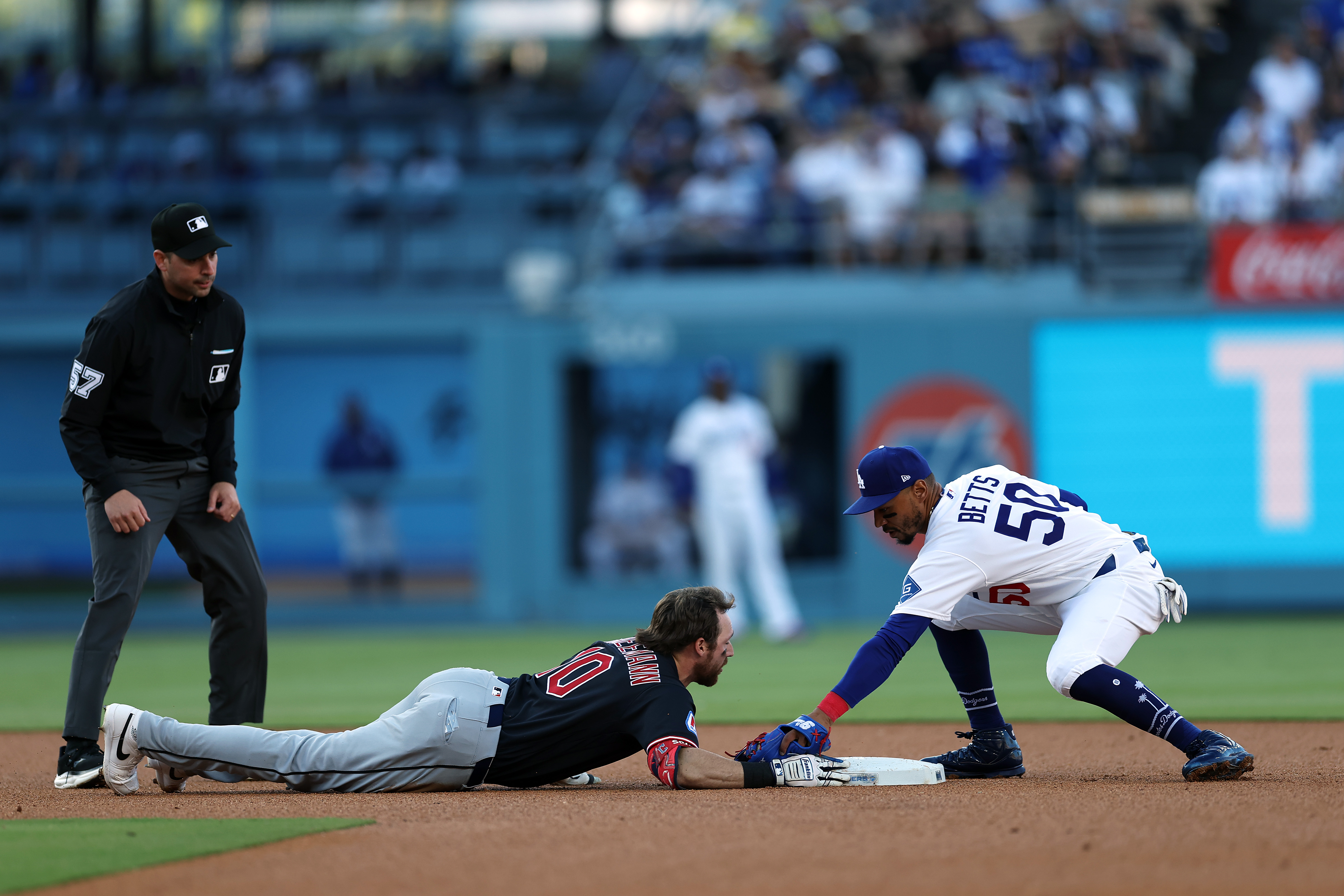 The Cleveland Guardians’ Daniel Schneemann slides safely into second base...
