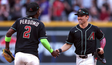 Corbin Carroll #7 shakes hands with Geraldo Perdomo #2 of the Arizona Diamondbacks...