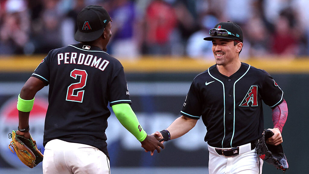 Corbin Carroll #7 shakes hands with Geraldo Perdomo #2 of the Arizona Diamondbacks...