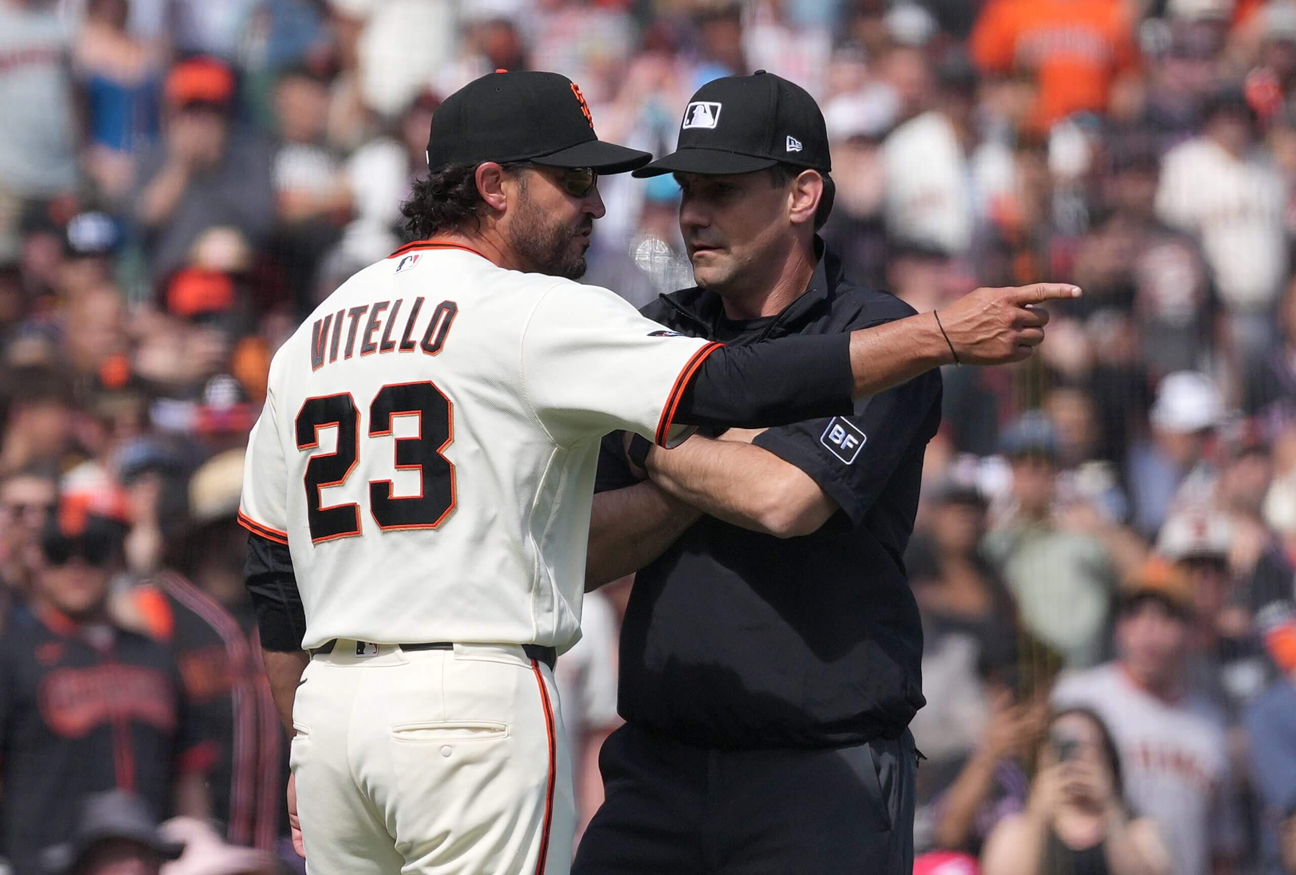 Giants manager Tony Vitello (No. 23) argues with third-base umpire Dave Rackley.