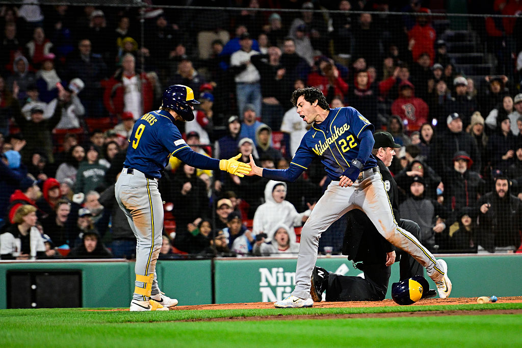 BOSTON, MASSACHUSETTS - APRIL 06: Jake Bauers #9 of the Milwaukee Brewers greets Christian Yelich #22 at home after Yelich scored in the eighth inning against the Boston Red Sox at Fenway Park on April 06, 2026 in Boston, Massachusetts. (Photo by Jaiden Tripi/Getty Images)