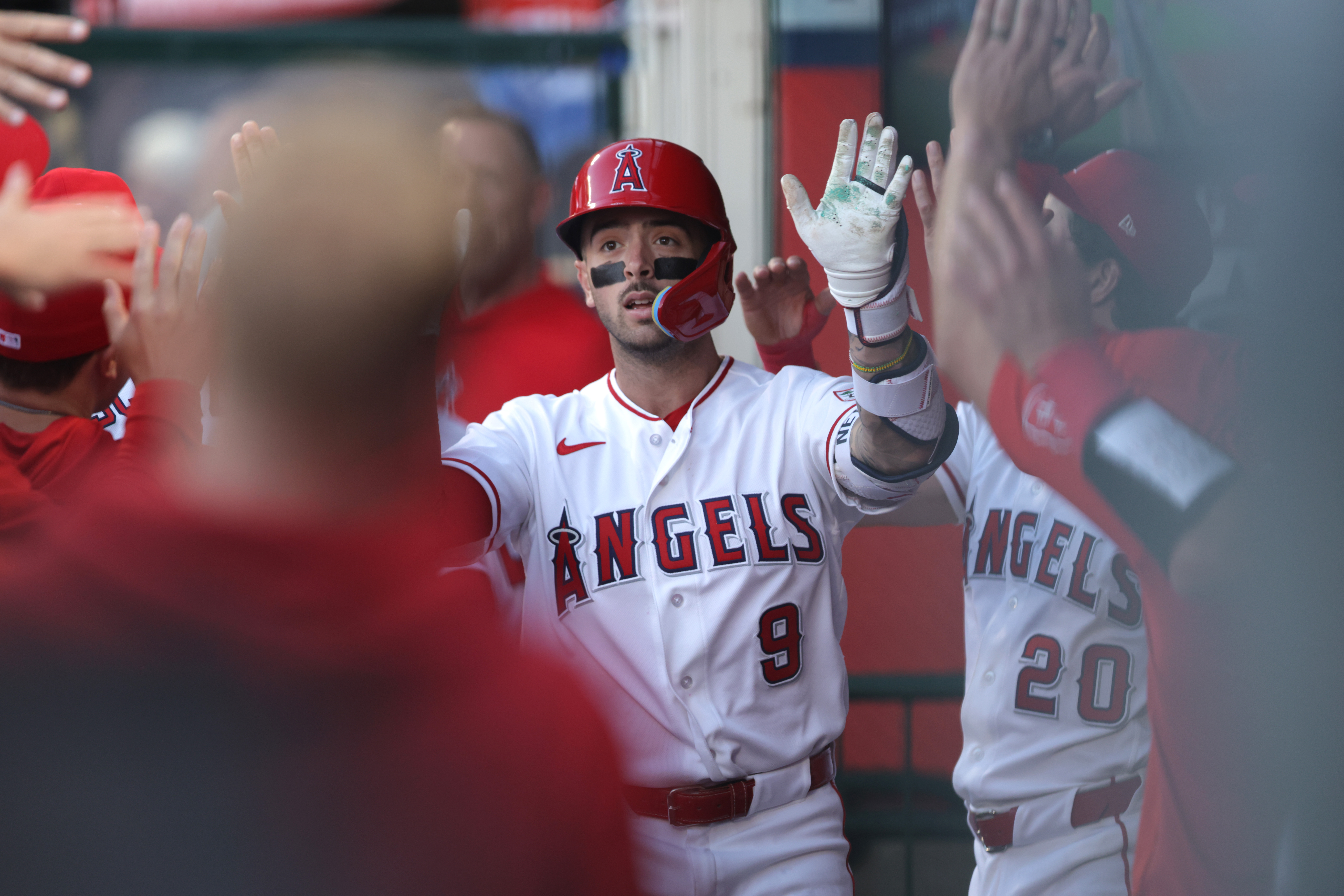 The Angels’ Zach Neto celebrates in the dugout after hitting...