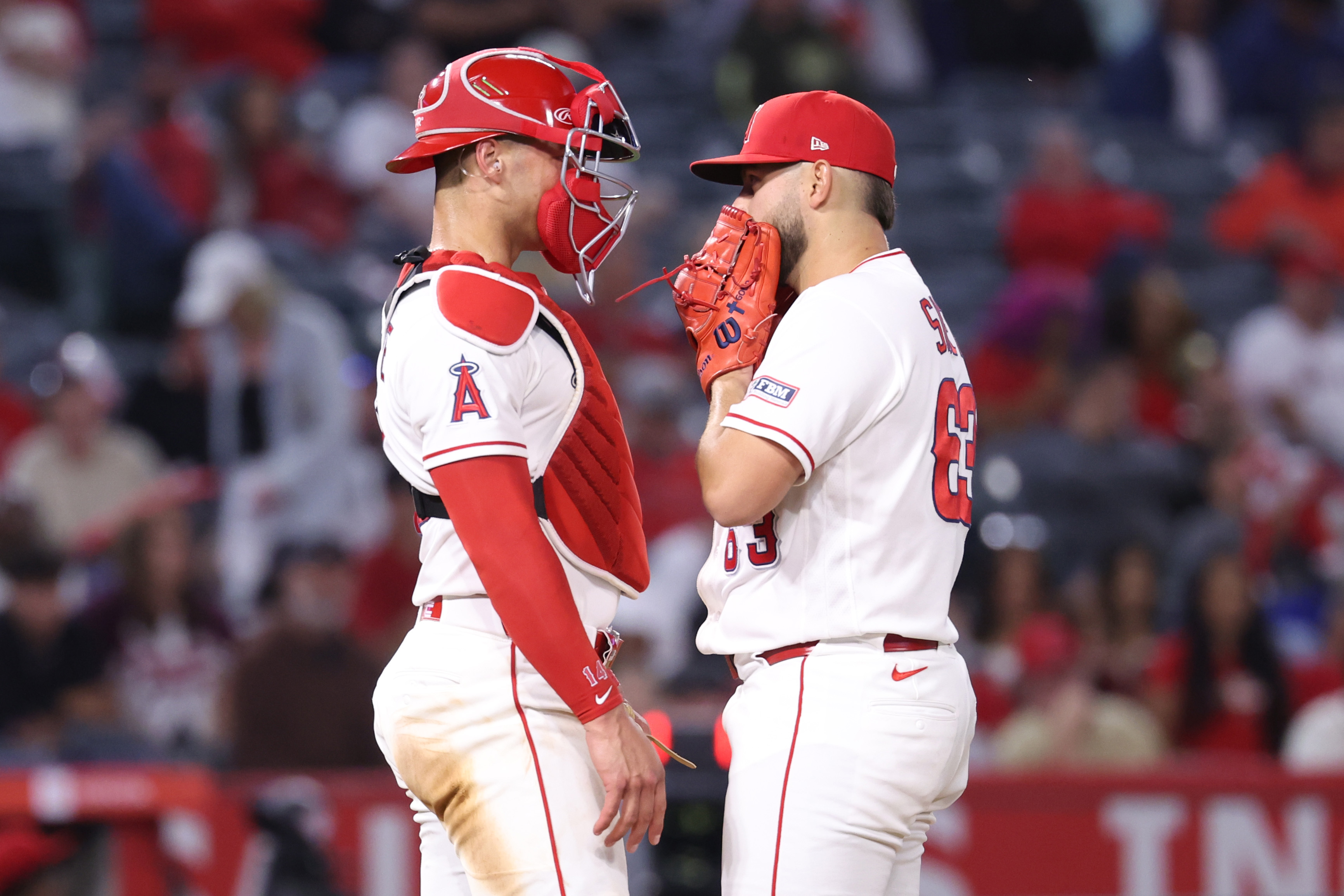 Angels catcher Logan O’Hoppe, left, has a chat at the...