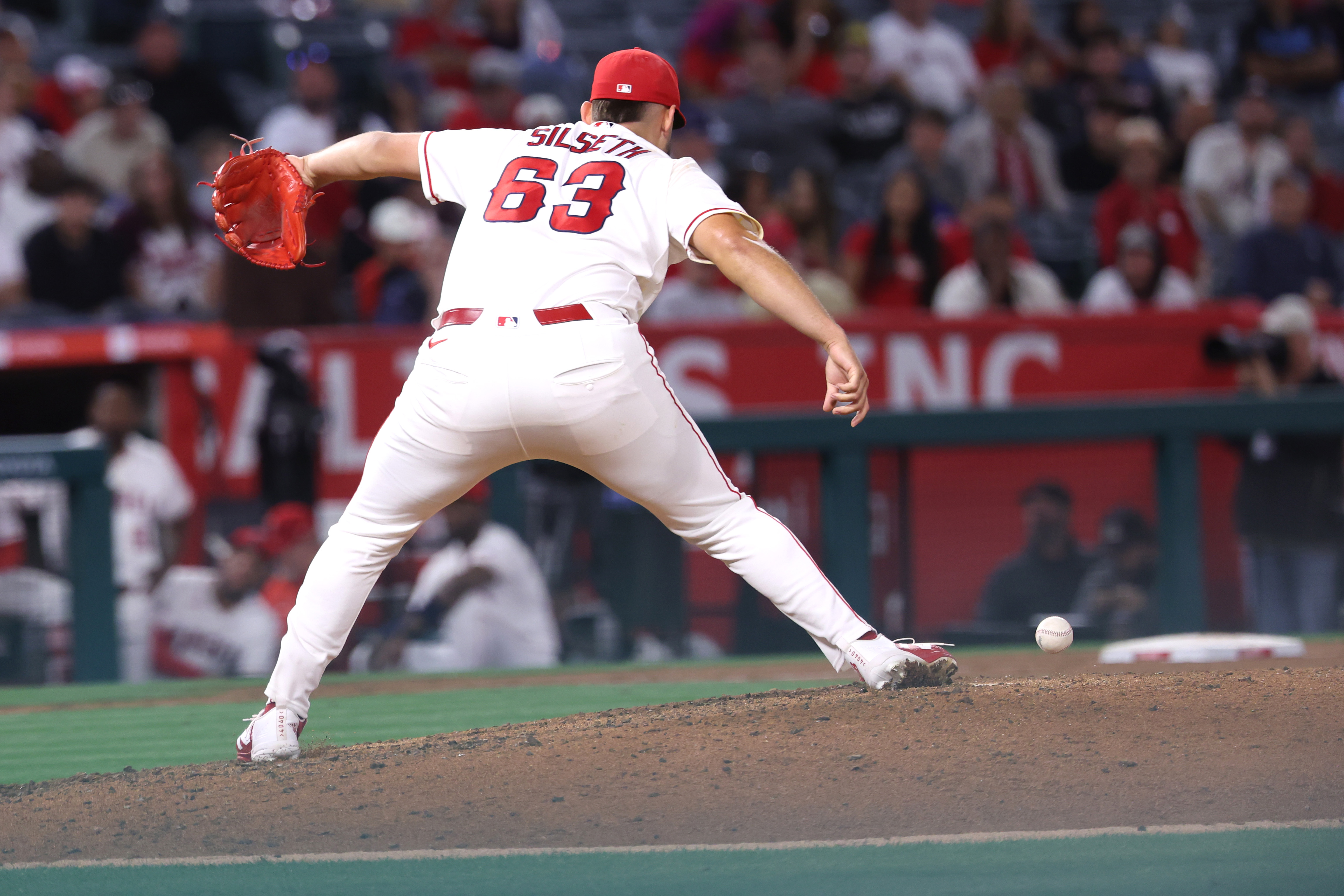 Angels relief pitcher Chase Silseth drops the ball mid-pitch during...