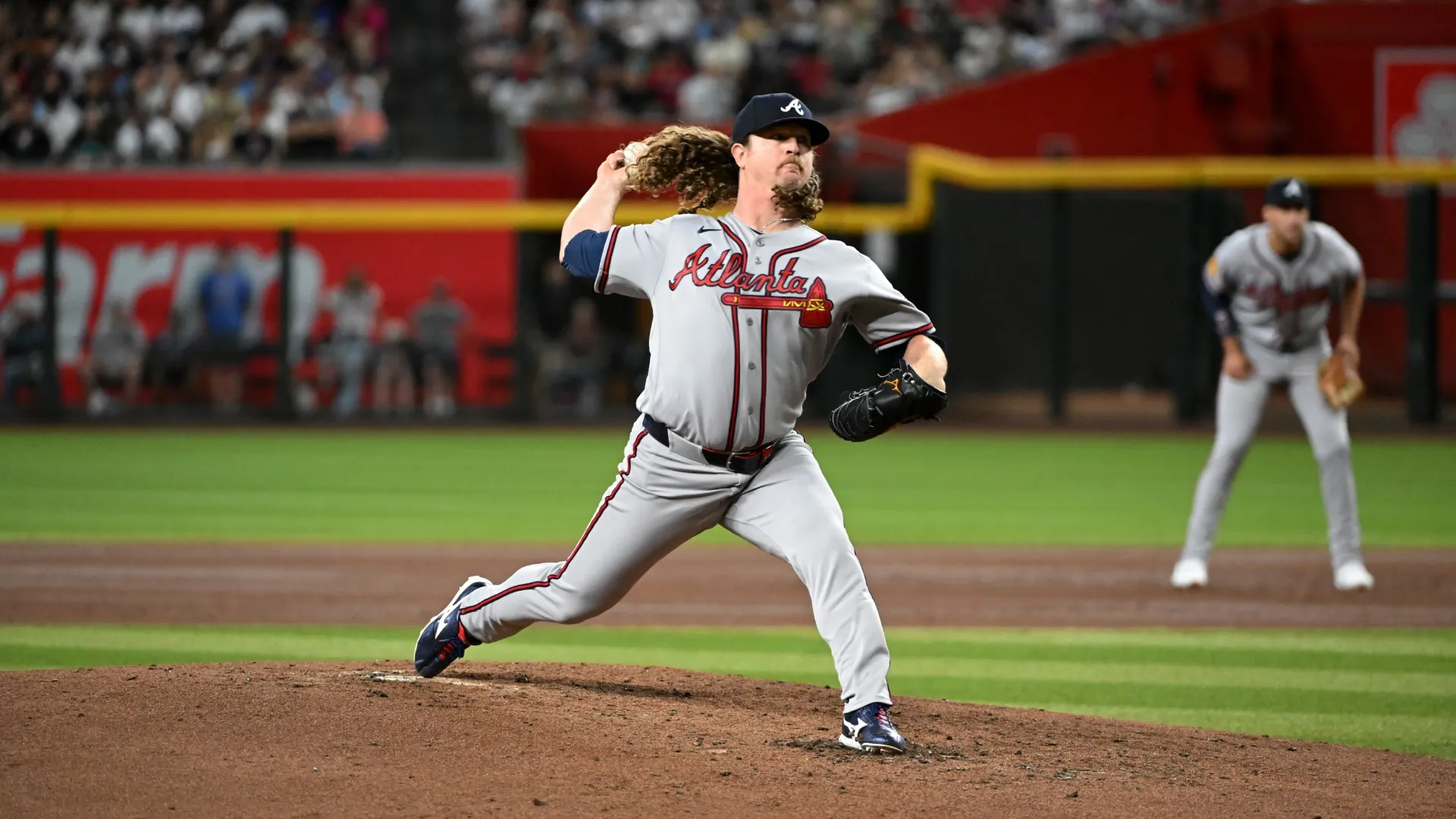 Grant Holmes #66 of the Braves delivers a sixth-inning pitch against the Diamondbacks. Norm Hall/Getty Images