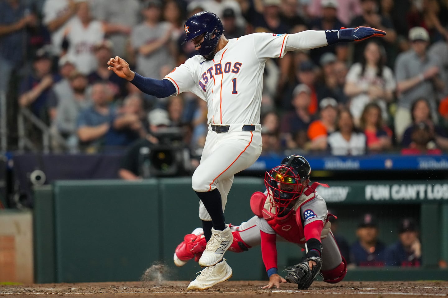 Carlos Correa beat the tag attempt by Red Sox catcher Connor Wong to score during the Astros' three-run fifth inning.