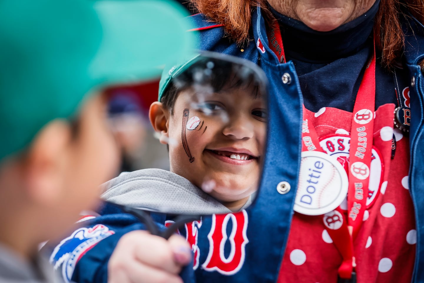 Julian Peña, 6, admires his face paint in a mirror before the Opening Day game.