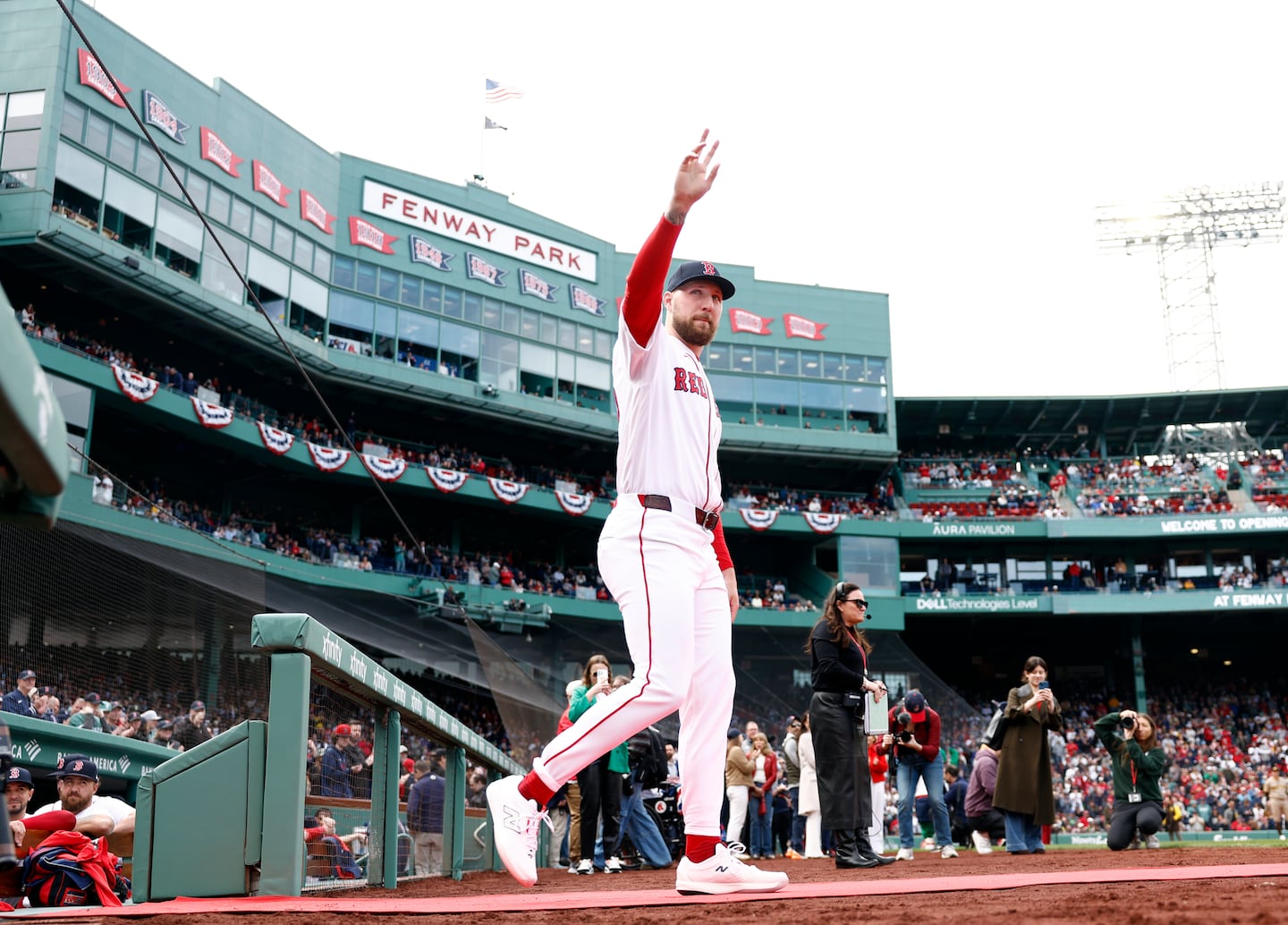 Pitcher Garrett Crochet walks onto the field before the opener at Fenway Park.