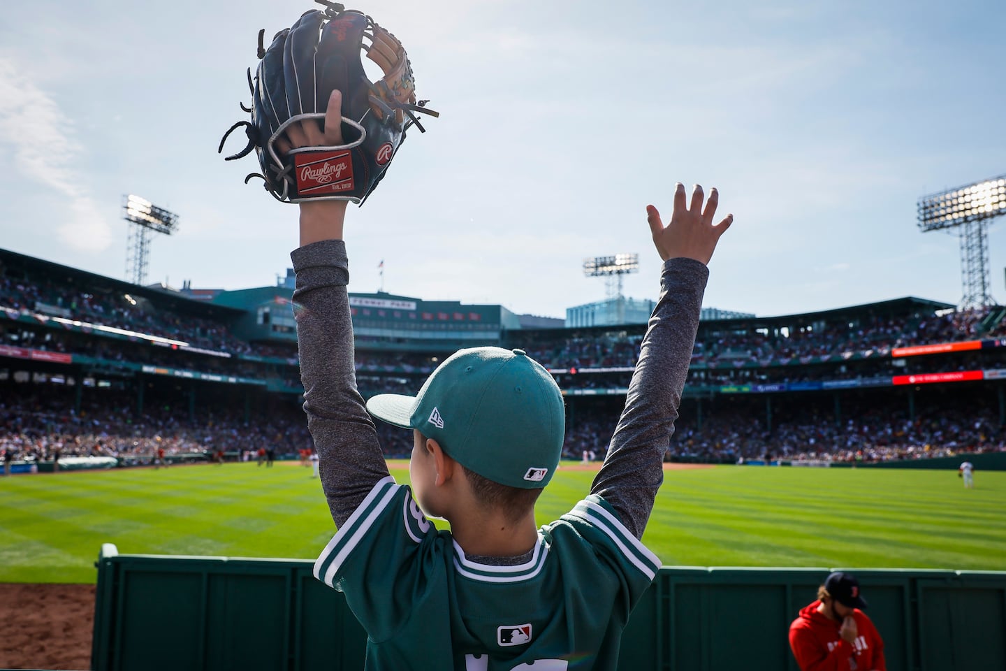 Jameson Rivenburgh, 10, waves for a ball from the outfield wall.