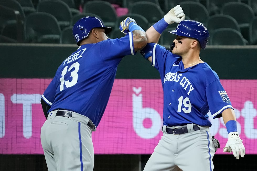 Kansas City Royals' Michael Massey (19) is congratulated by teammate Salvador Perez (13) after...