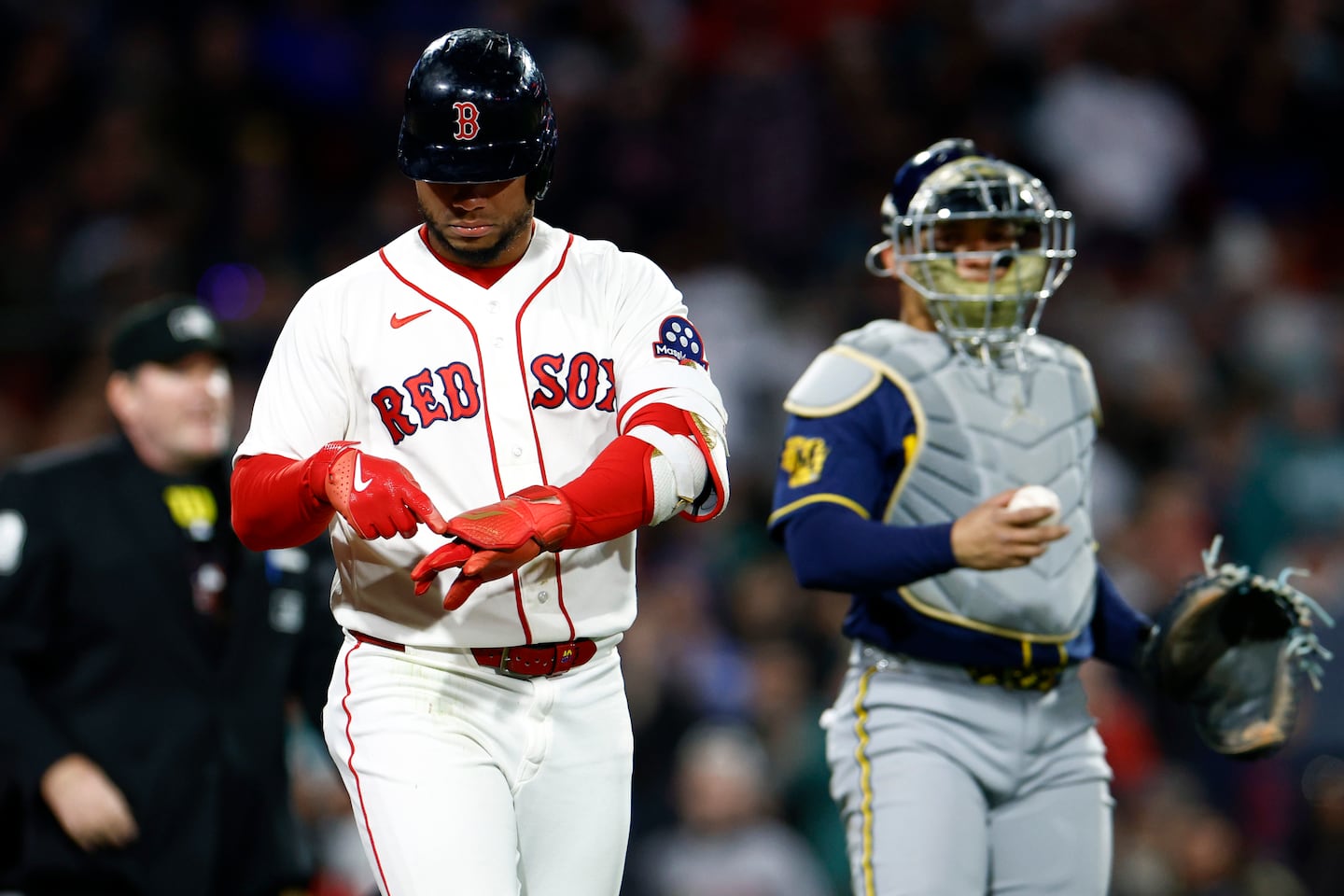 With his brother, Brewers catcher William Contreras, looking on, Willson Contreras pointed to where a pitch hit his hand in the third inning at Fenway Park on Monday night.