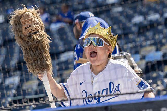 A young fan cheers while watching Kansas City Royals first baseman Vinnie Pasquantino (9) during batting practice before the home opener against the Minnesota Twins at Kauffman Stadium on Monday, March 30, 2026, in Kansas City.
