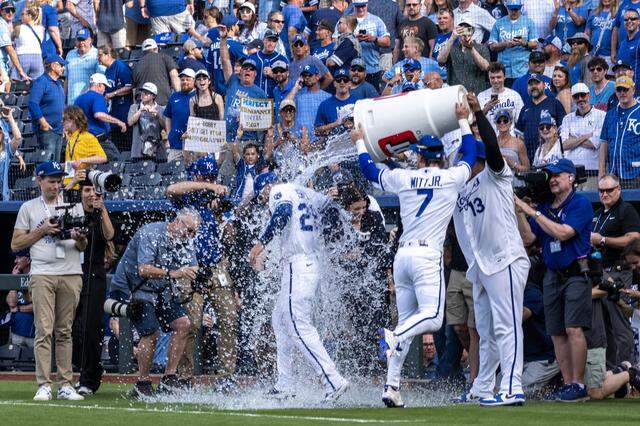 Kansas City Royals center fielder Kyle Isbel (28) is doused by shortstop Bobby Witt Jr. (7) and catcher Salvador Perez (13) after winning 3-1 for for an home opening game against the Minnesota Twins at Kauffman Stadium on Monday, March 30, 2026, in Kansas City.