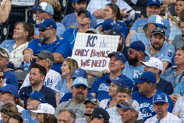 Royals fans hold up a sign during a home opening game between the Kansas City Royals and the Minnesota Twins at Kauffman Stadium on Monday, March 30, 2026, in Kansas City.