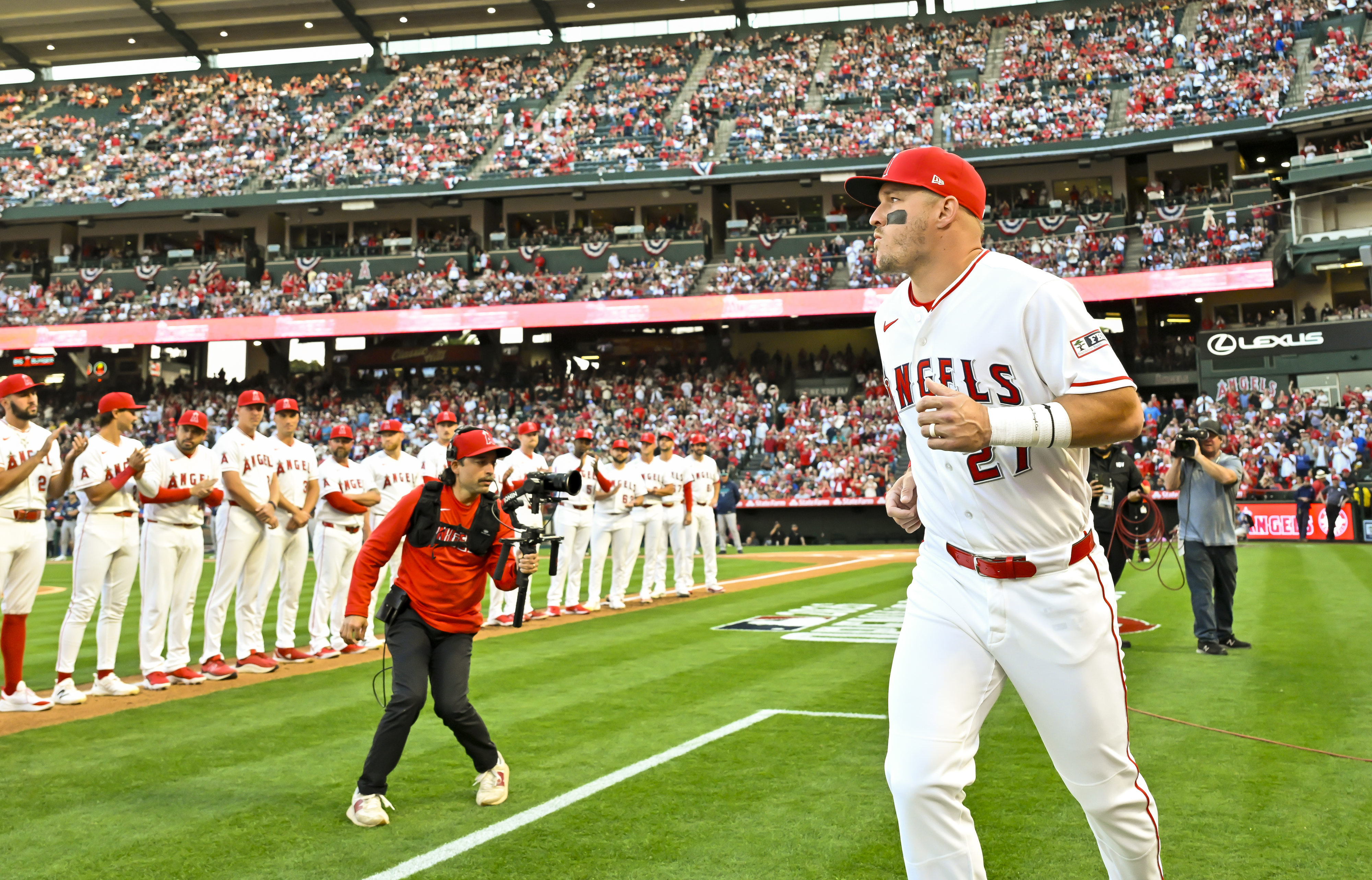 Mike Trout (27) of the Angels takes the field after...