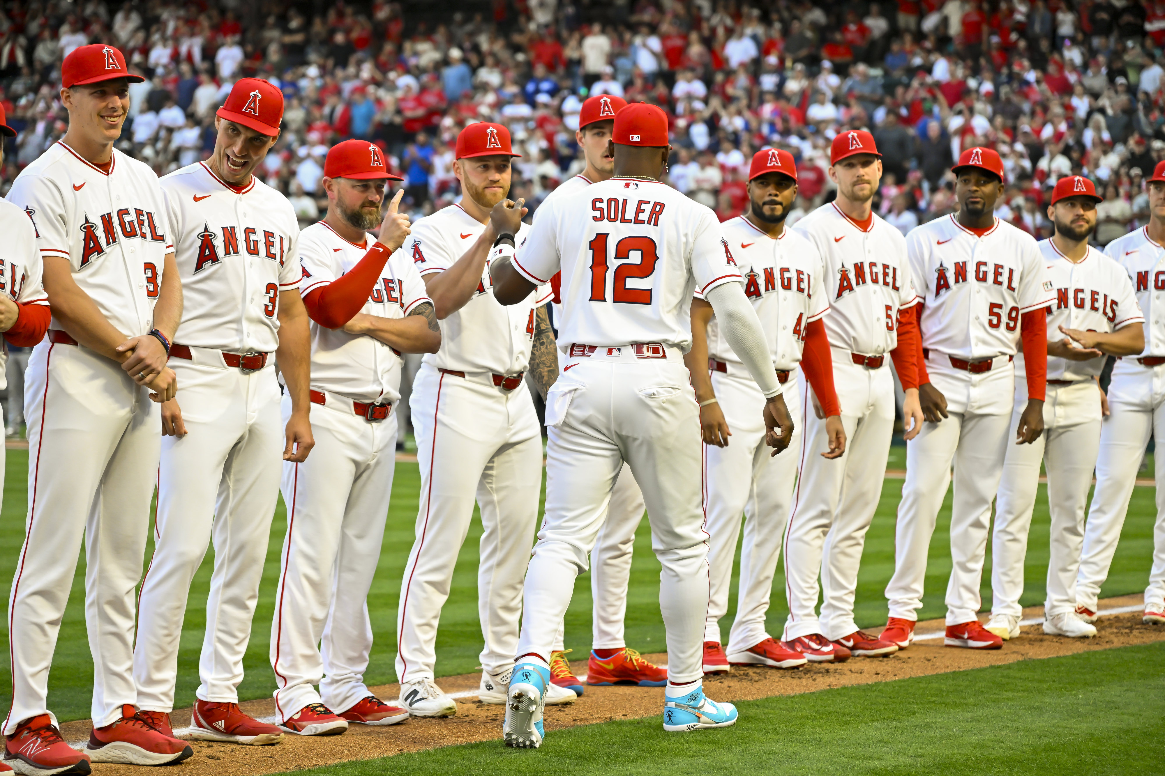 Jorge Soler (12) of the Angels greets teammates after being...