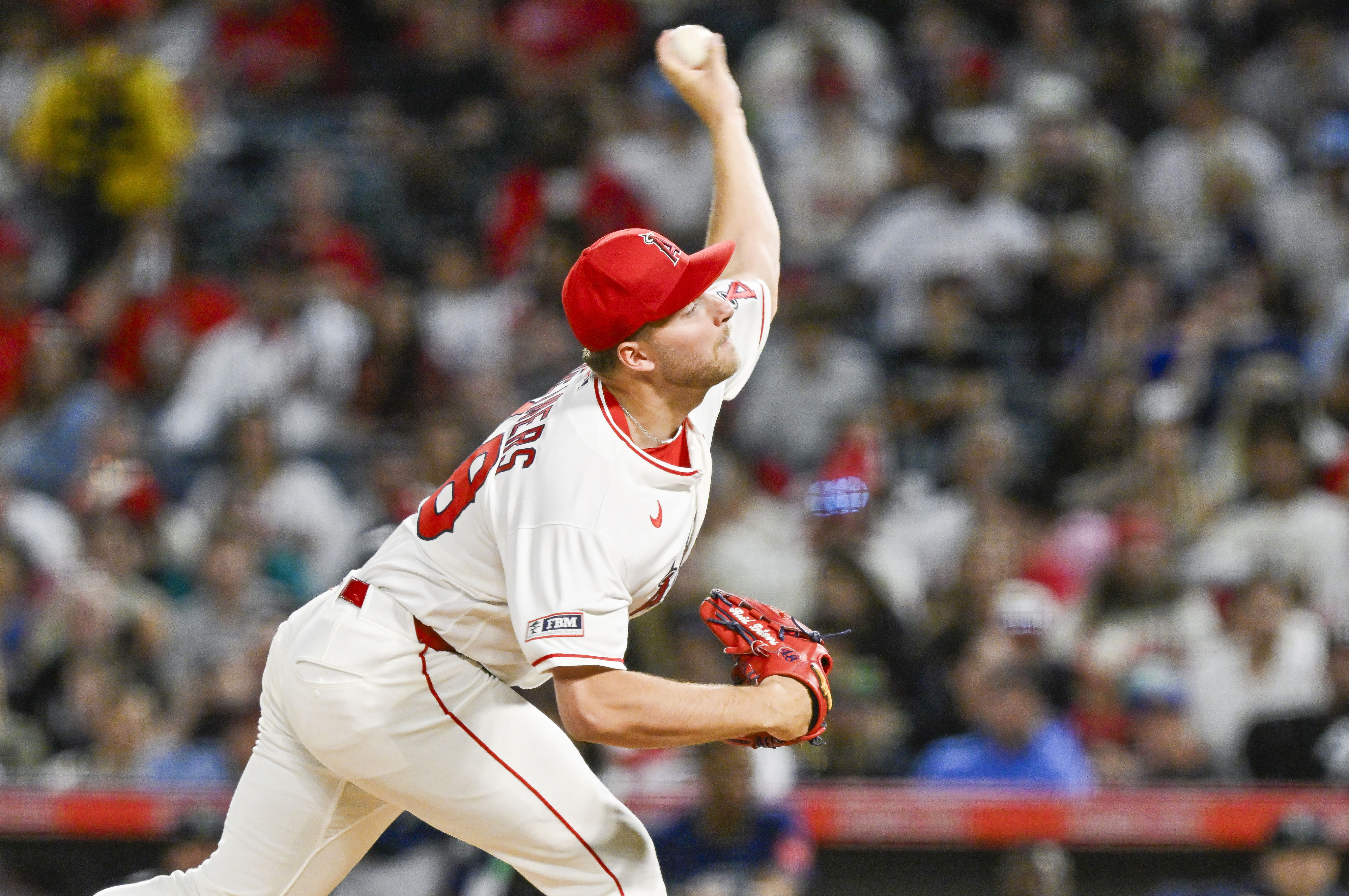 Angels starting pitcher Reid Detmers throws to the plate during...