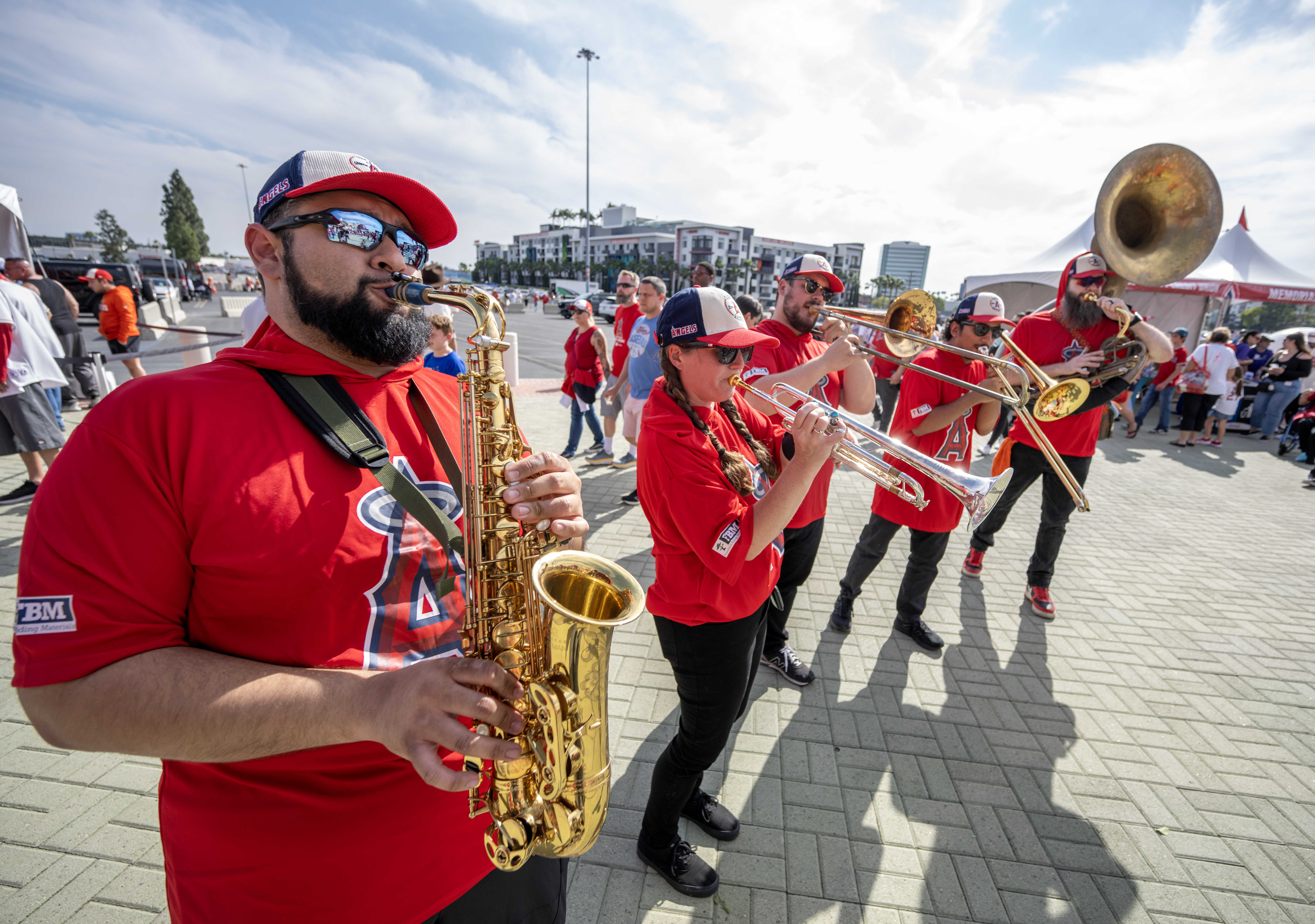 A brass band plays in front of the homeplate gate...