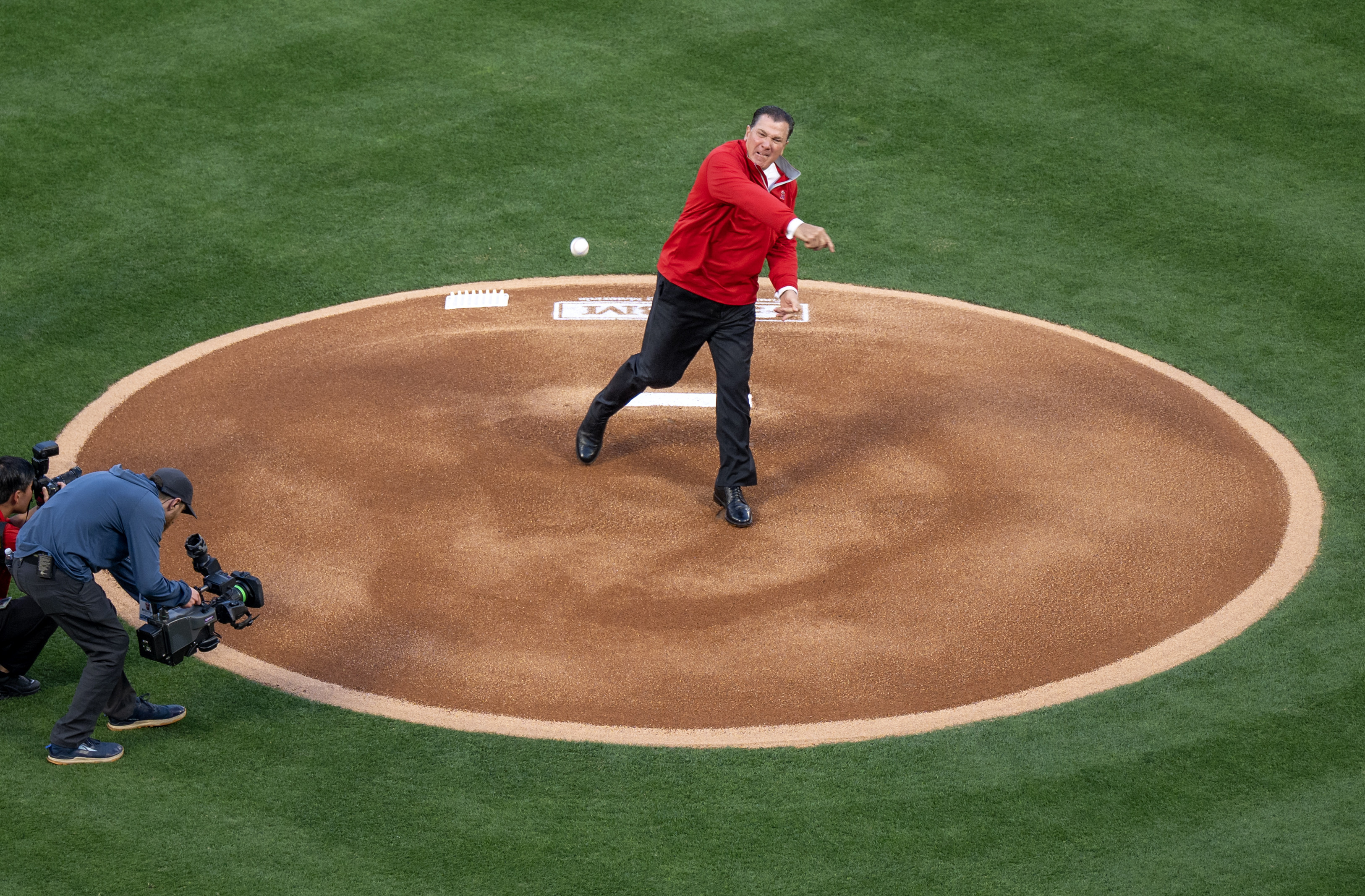 Team President John Carpino throws out the first pitch before...