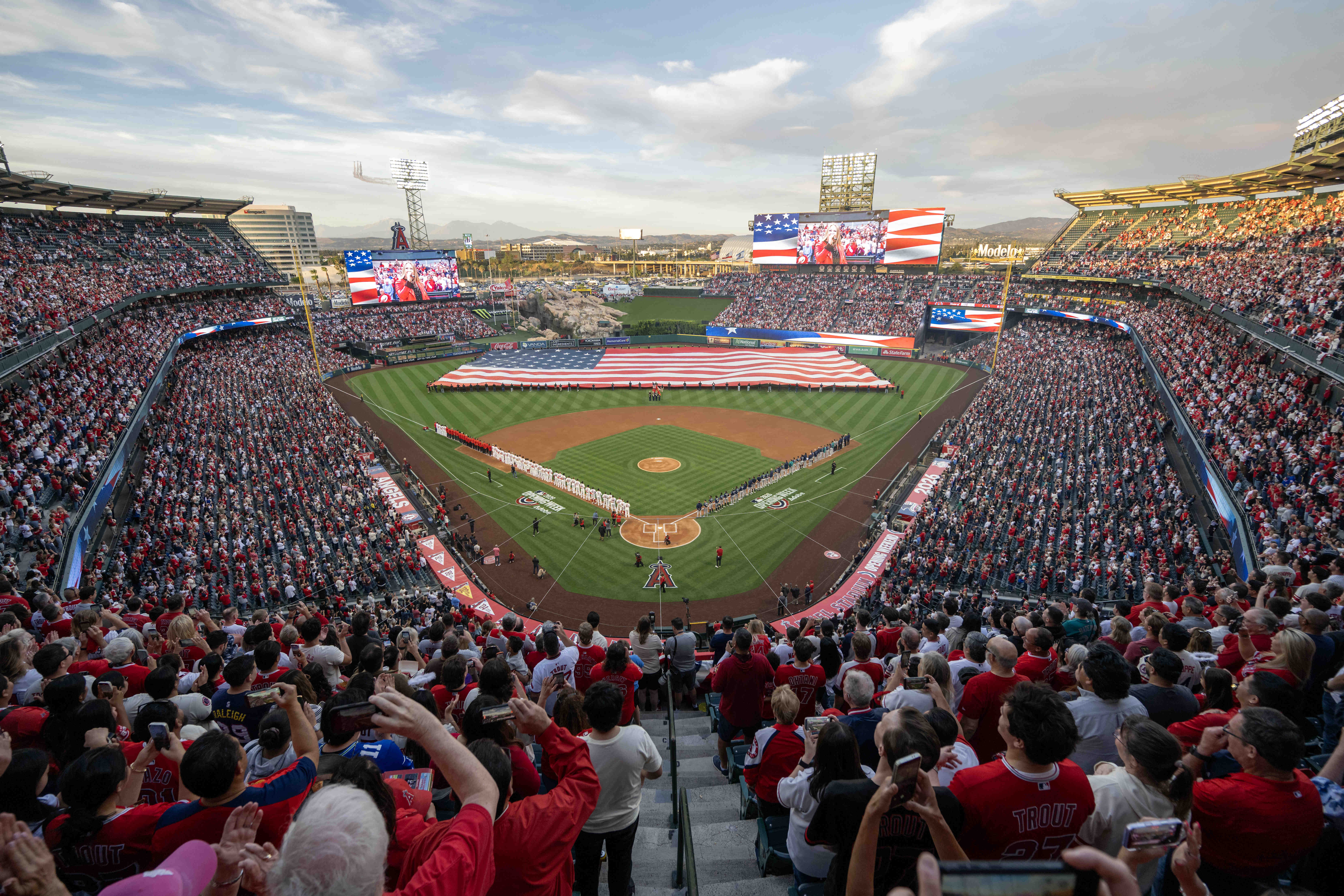 A giant American flag is unfurled during the National Anthem...