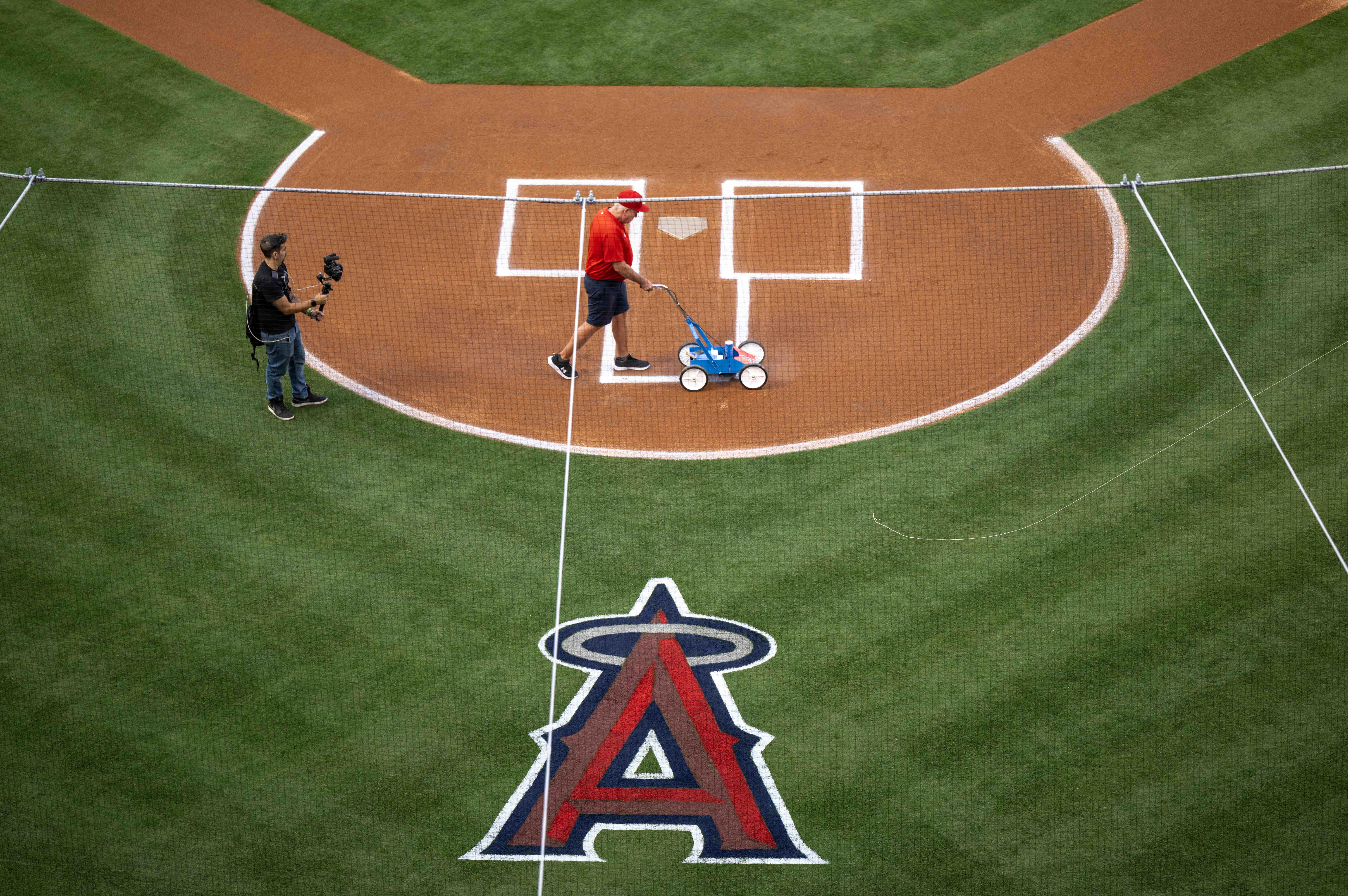 Grounds crews prepare the field for the start of the...