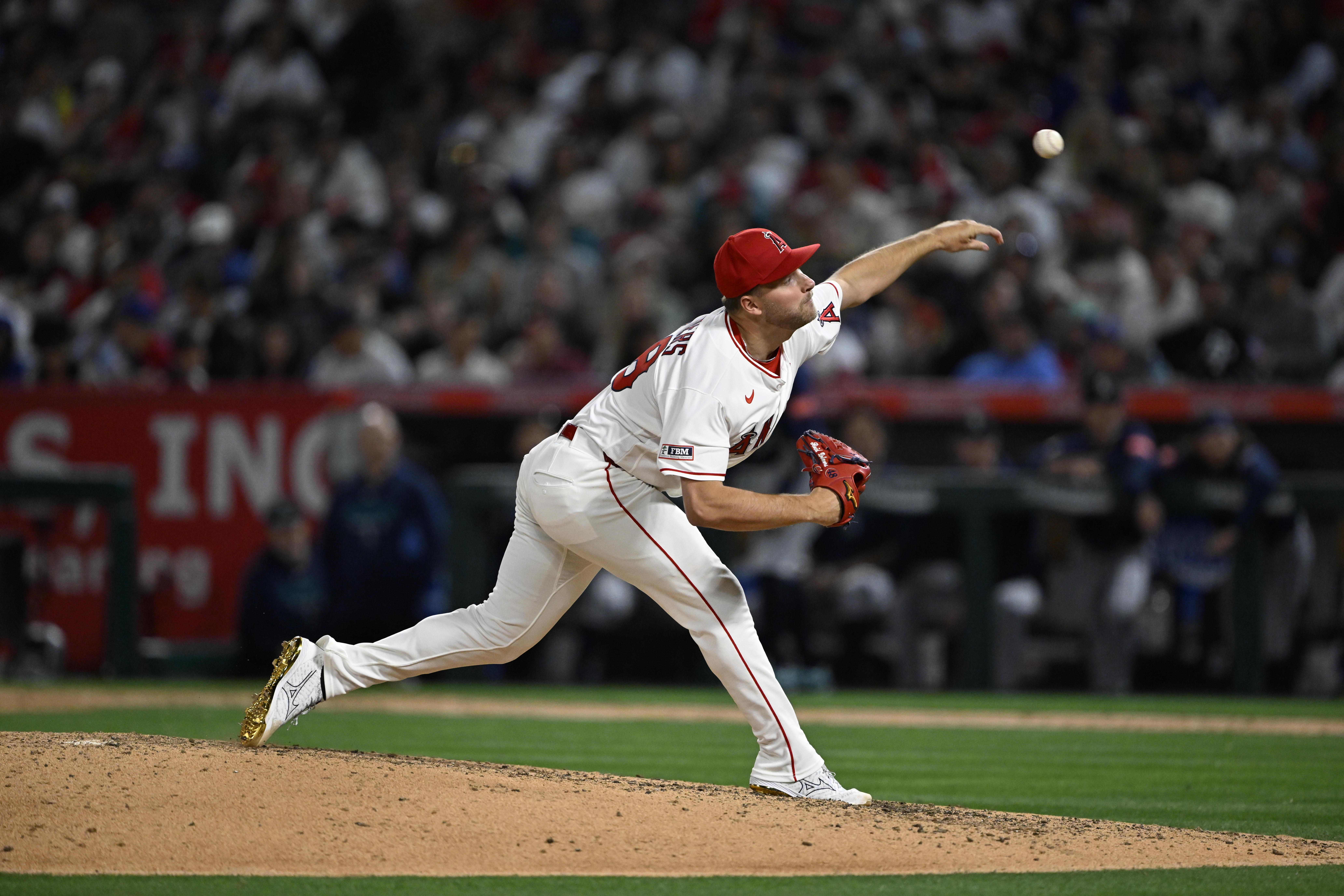 Angels starting pitcher Reid Detmers throws to the plate during...