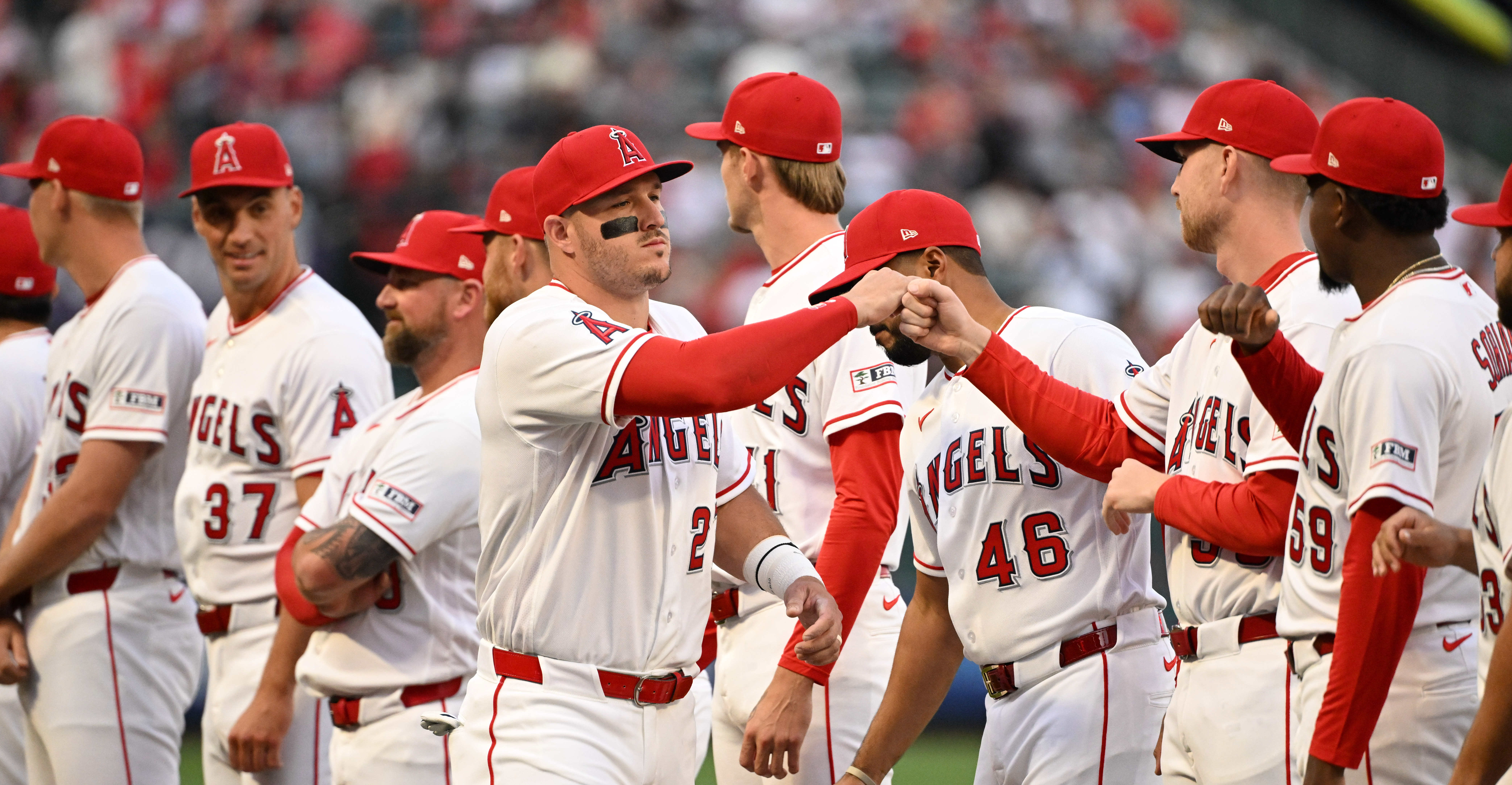 Angels star Mike Trout (27) greets teammates during pregame festivities...