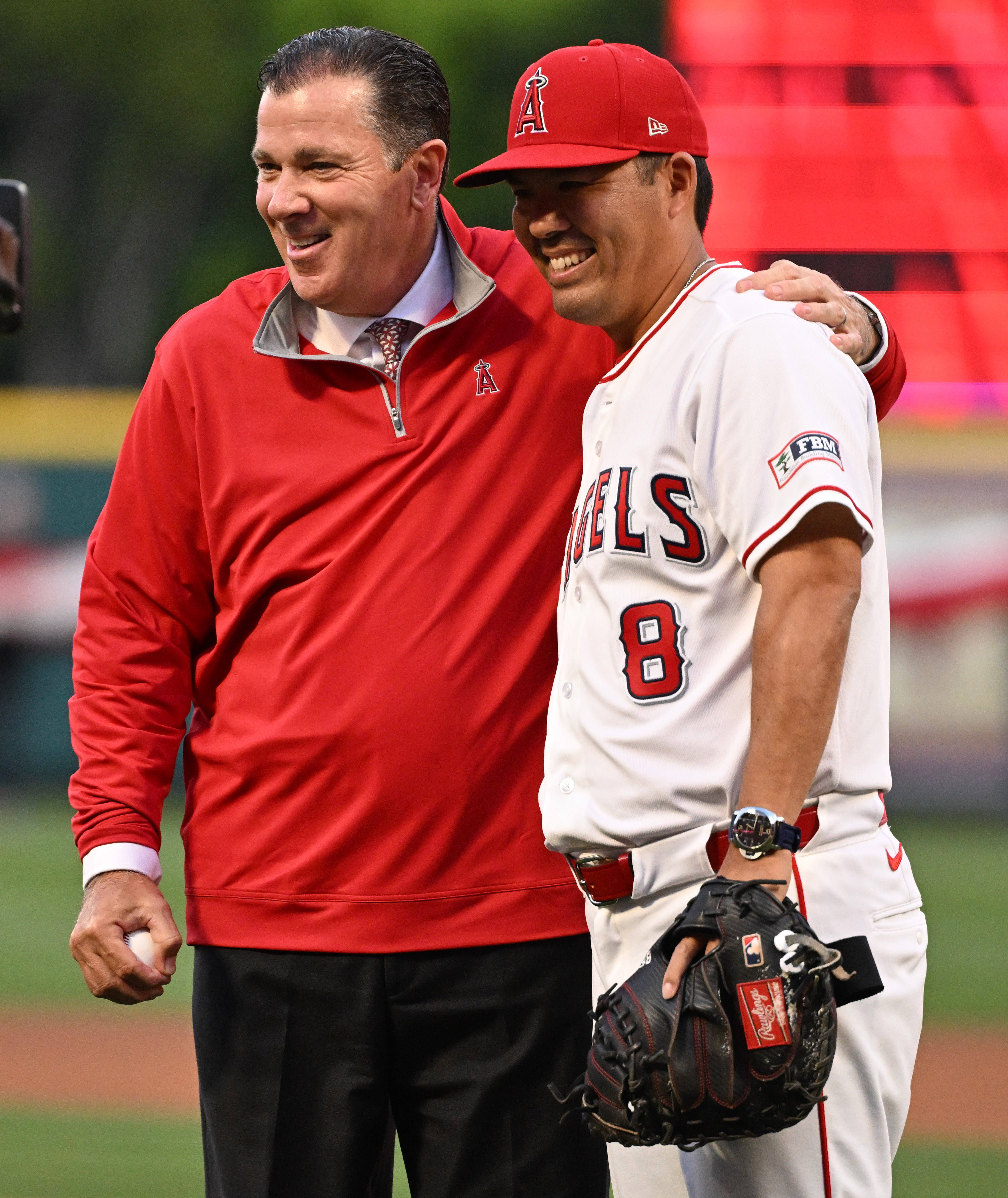 Angels President John Carpino twith manager Kurt Suzuki #8 of...