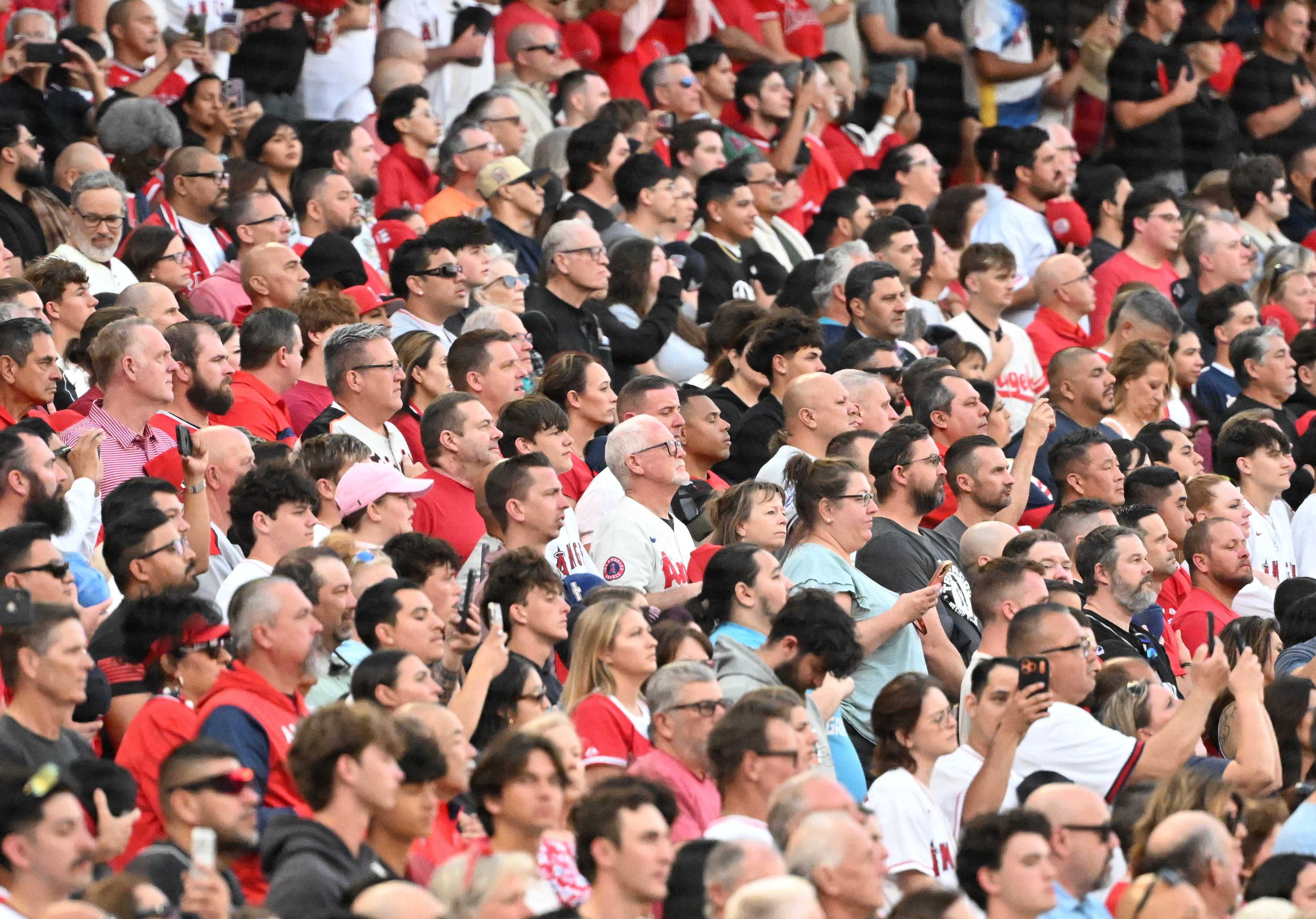 Fans watch from the stands during pregame festivities before the...